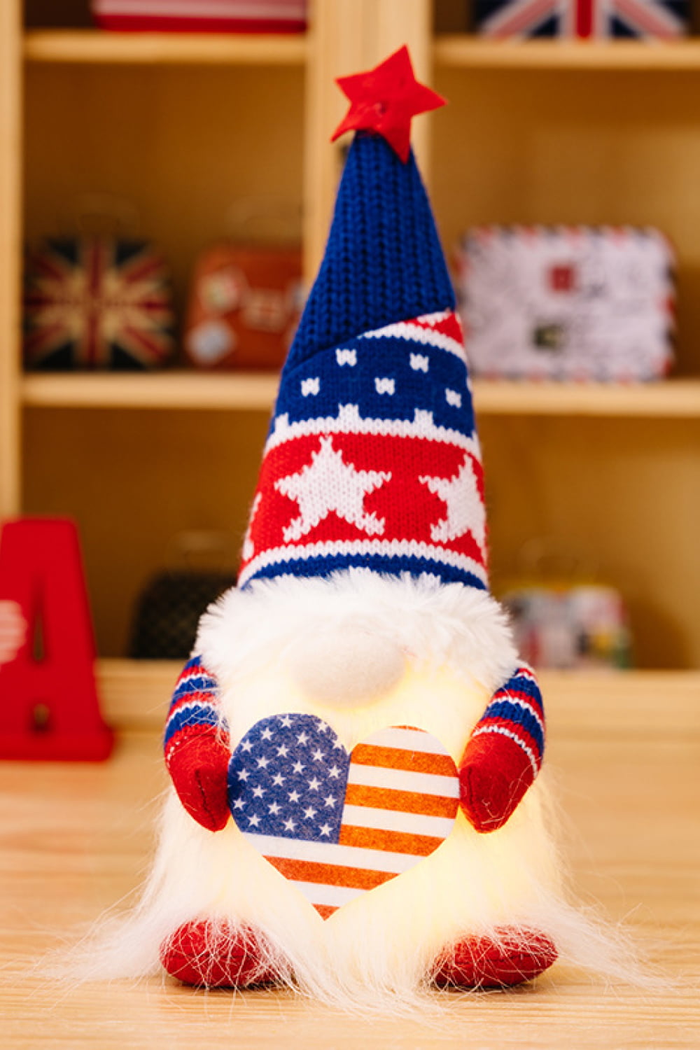 Two charming Independence Day gnomes made of knit fabric, featuring festive colors and designs, perfect for holiday decor.