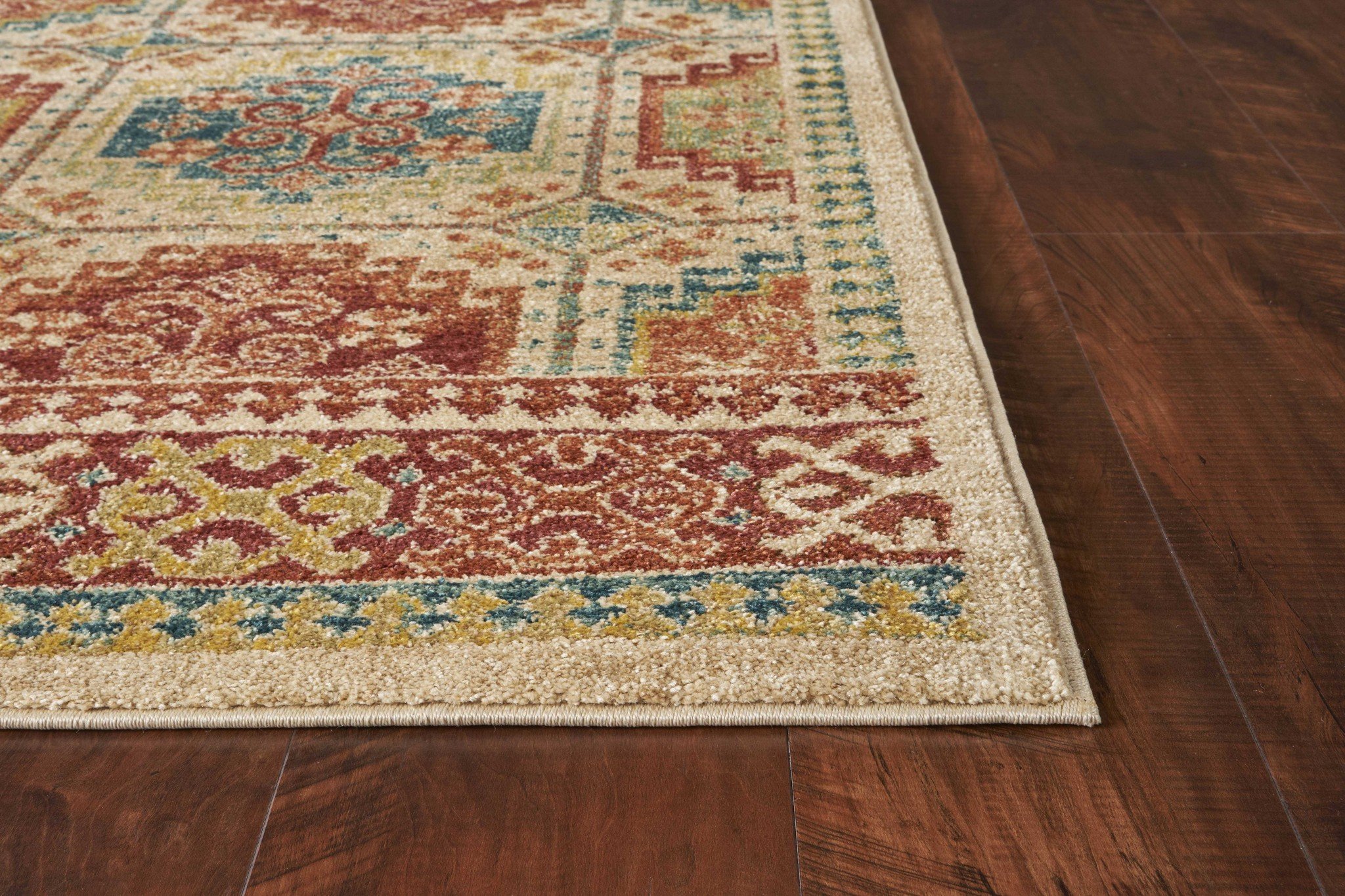 A vintage-inspired 31" X 96" sand-colored polypropylene rug with intricate patterns, showcasing its soft texture and distressed design.