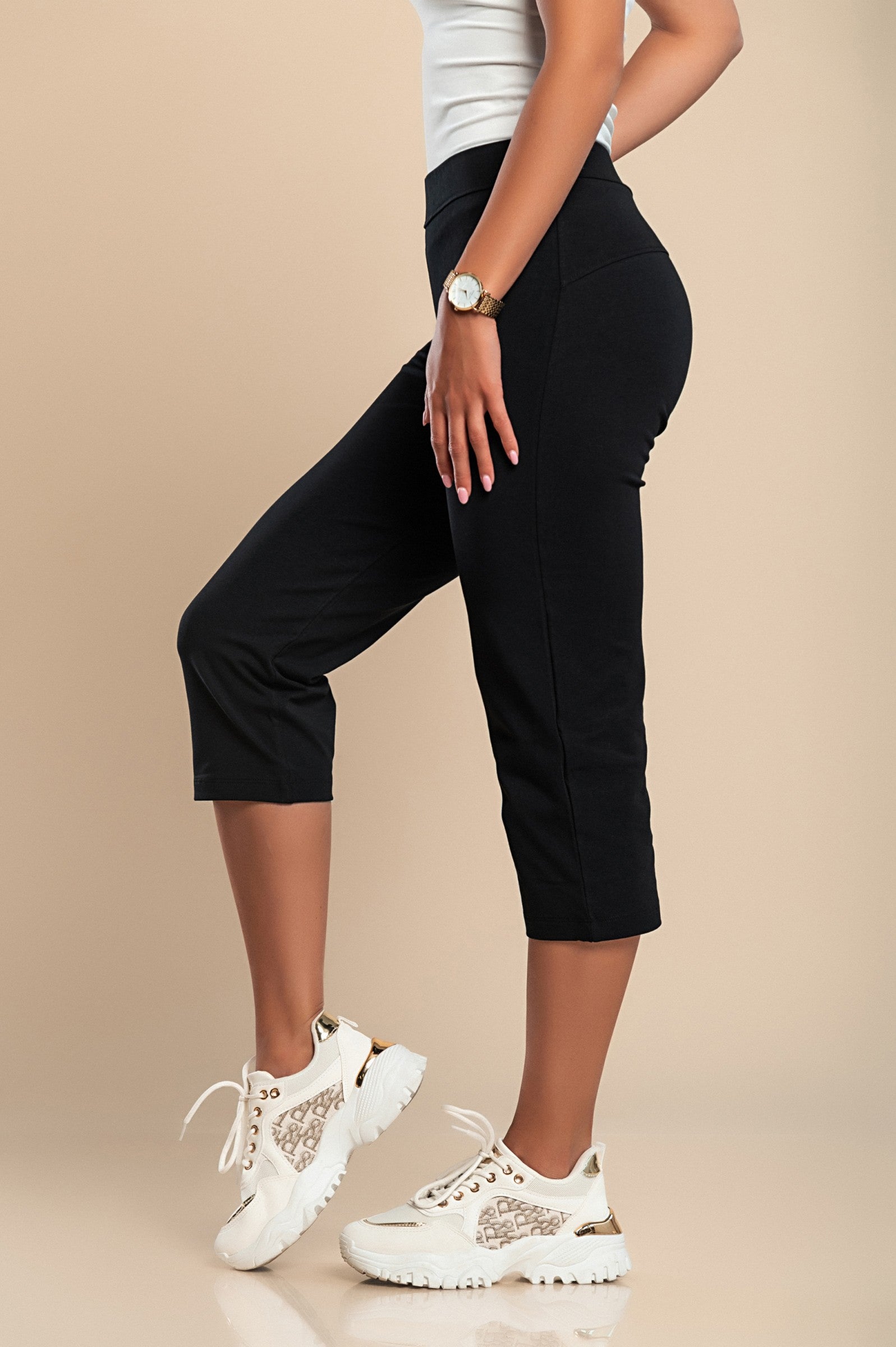 A pair of black 3/4 cotton sports pants featuring an elasticated waist and fitted design, suitable for various sports activities.