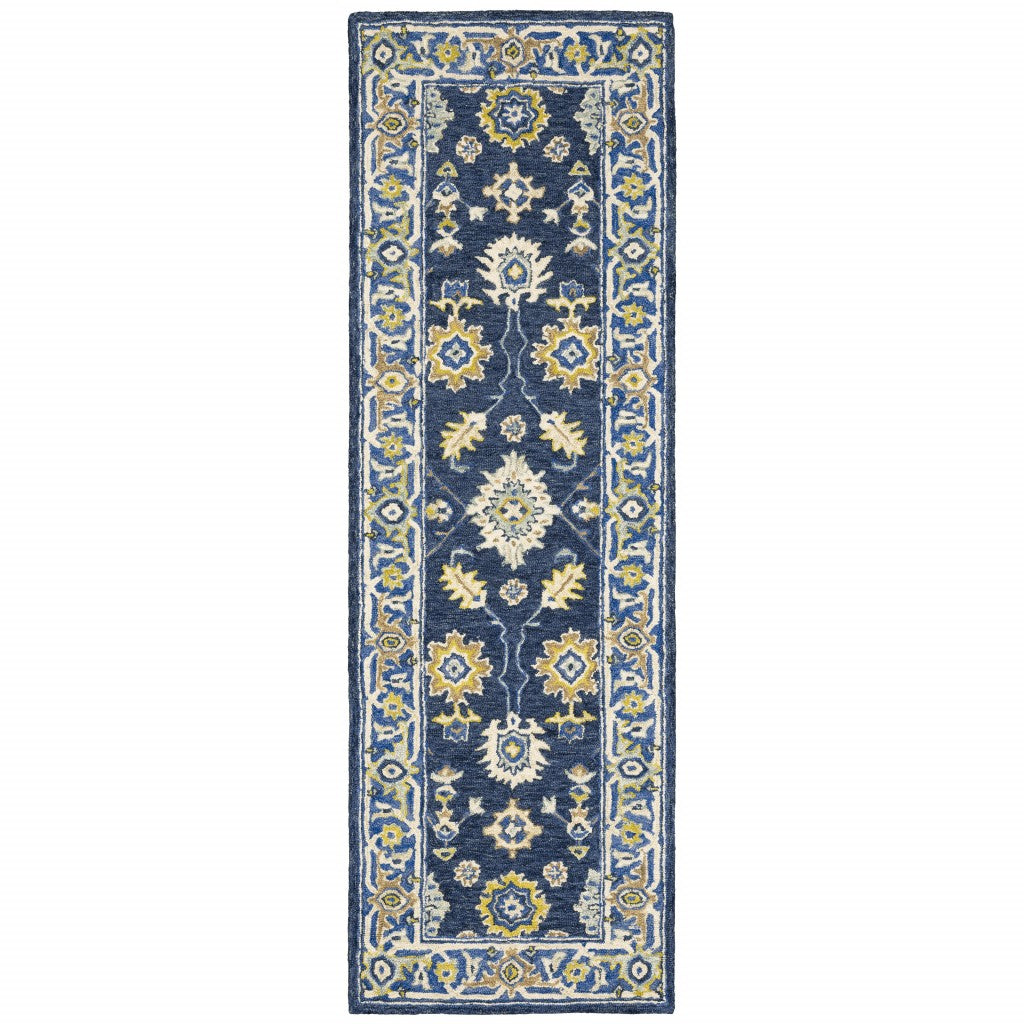 Navy and blue bohemian area rug with floral motifs on a muted navy backdrop, showcasing vibrant colors and luxurious wool texture.