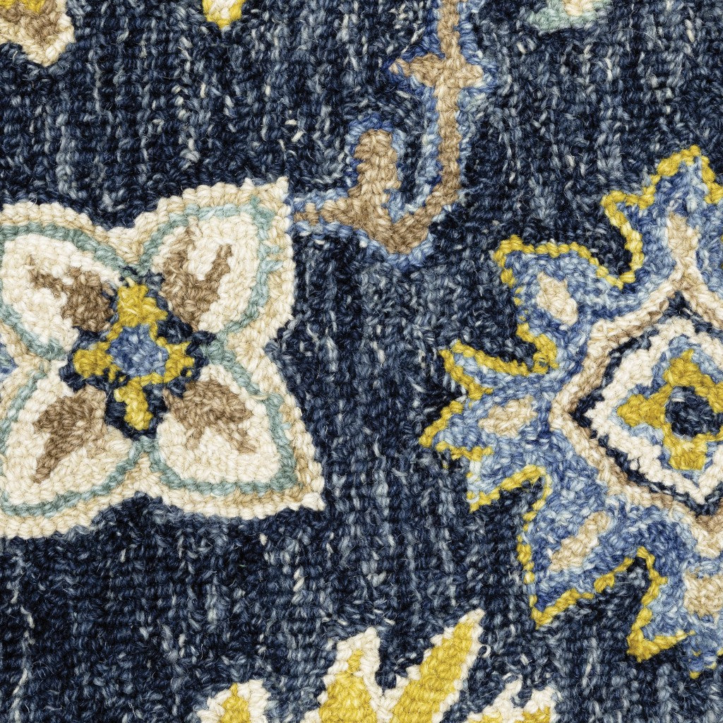 Navy and blue bohemian area rug with floral motifs on a muted navy backdrop, showcasing vibrant colors and luxurious wool texture.