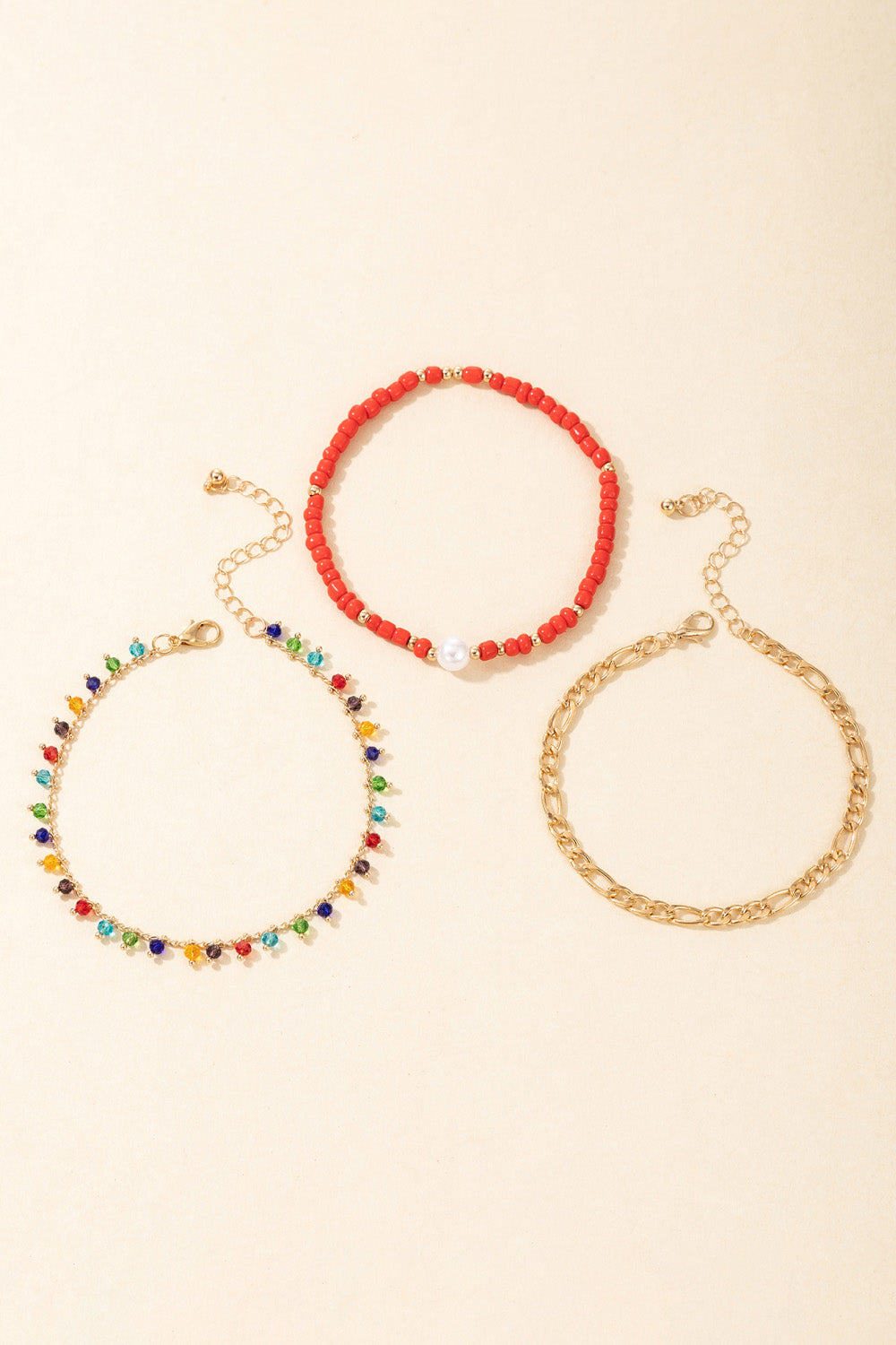 3-Piece Zinc Alloy Ankle Bracelet Set featuring red bead, gold chain, and multicolored bead designs, showcasing ethnic and geometric styles.