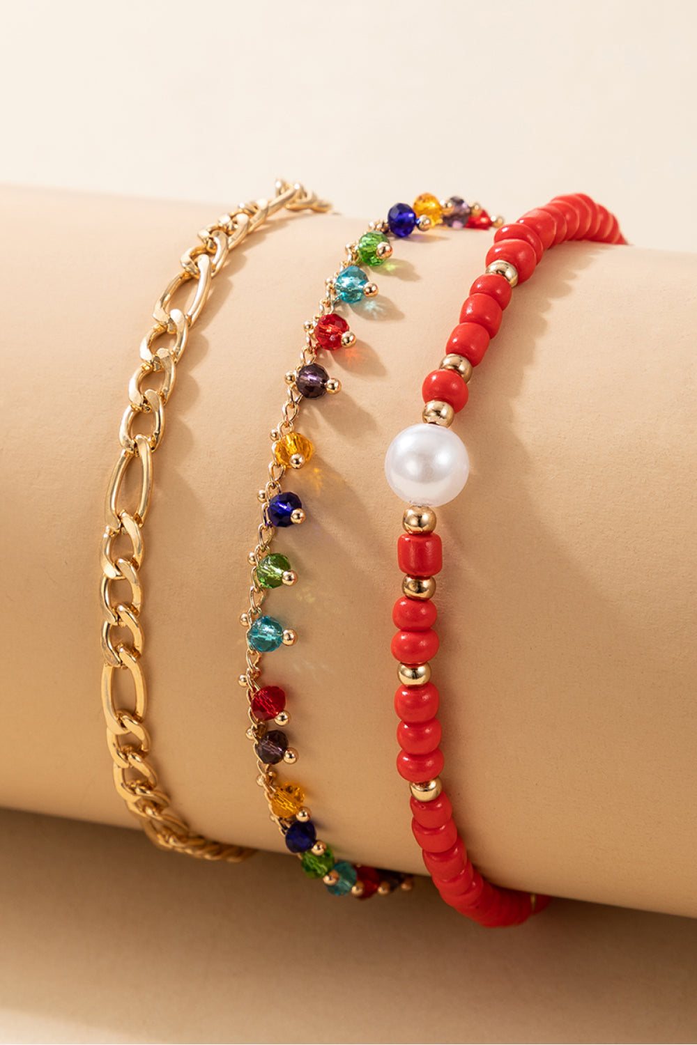 3-Piece Zinc Alloy Ankle Bracelet Set featuring red bead, gold chain, and multicolored bead designs, showcasing ethnic and geometric styles.