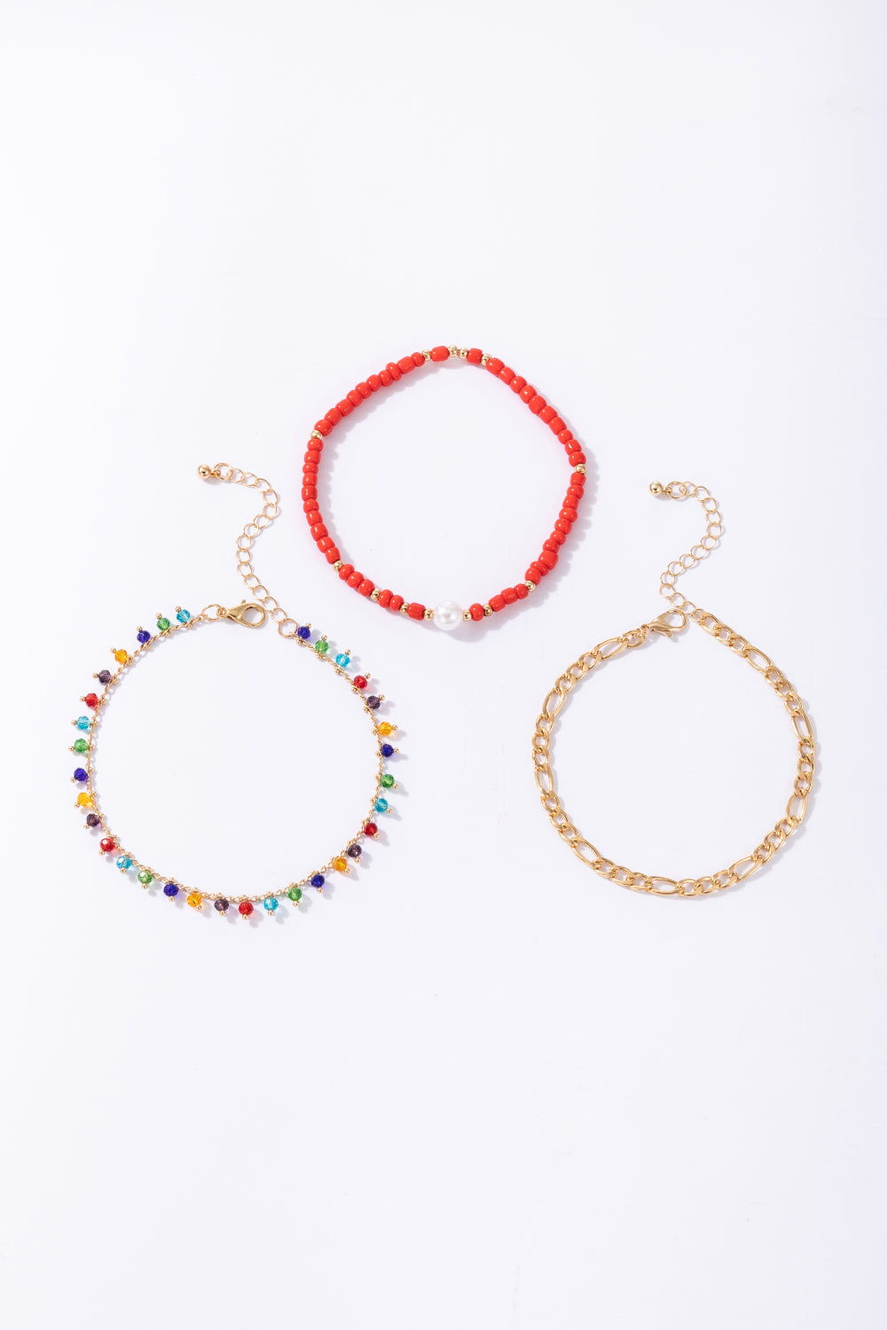 3-Piece Zinc Alloy Ankle Bracelet Set featuring red bead, gold chain, and multicolored bead designs, showcasing ethnic and geometric styles.