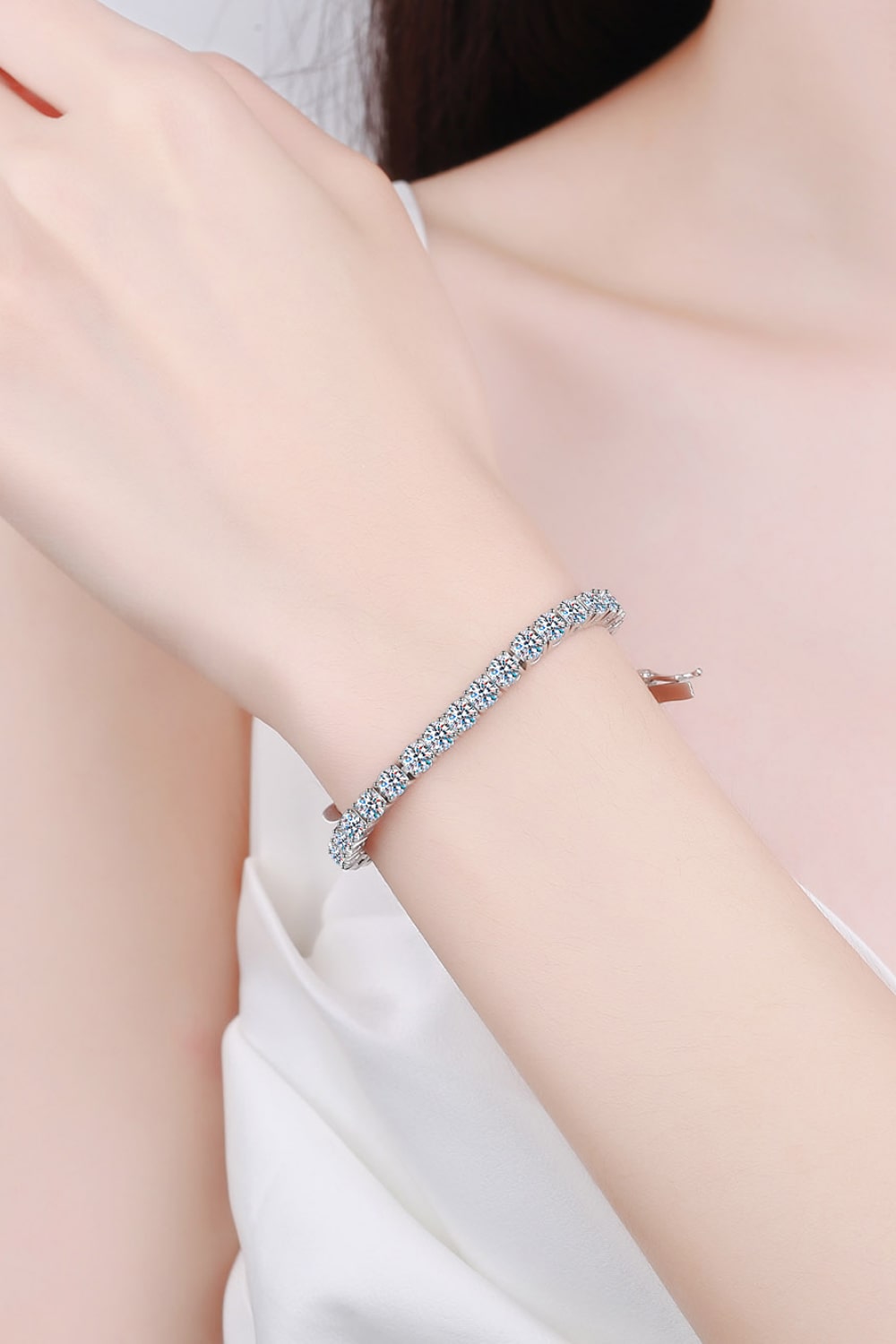 A stunning 4.9 Carat Moissanite Bracelet made of polished 925 sterling silver, showcasing its minimalist design and sparkling stones.