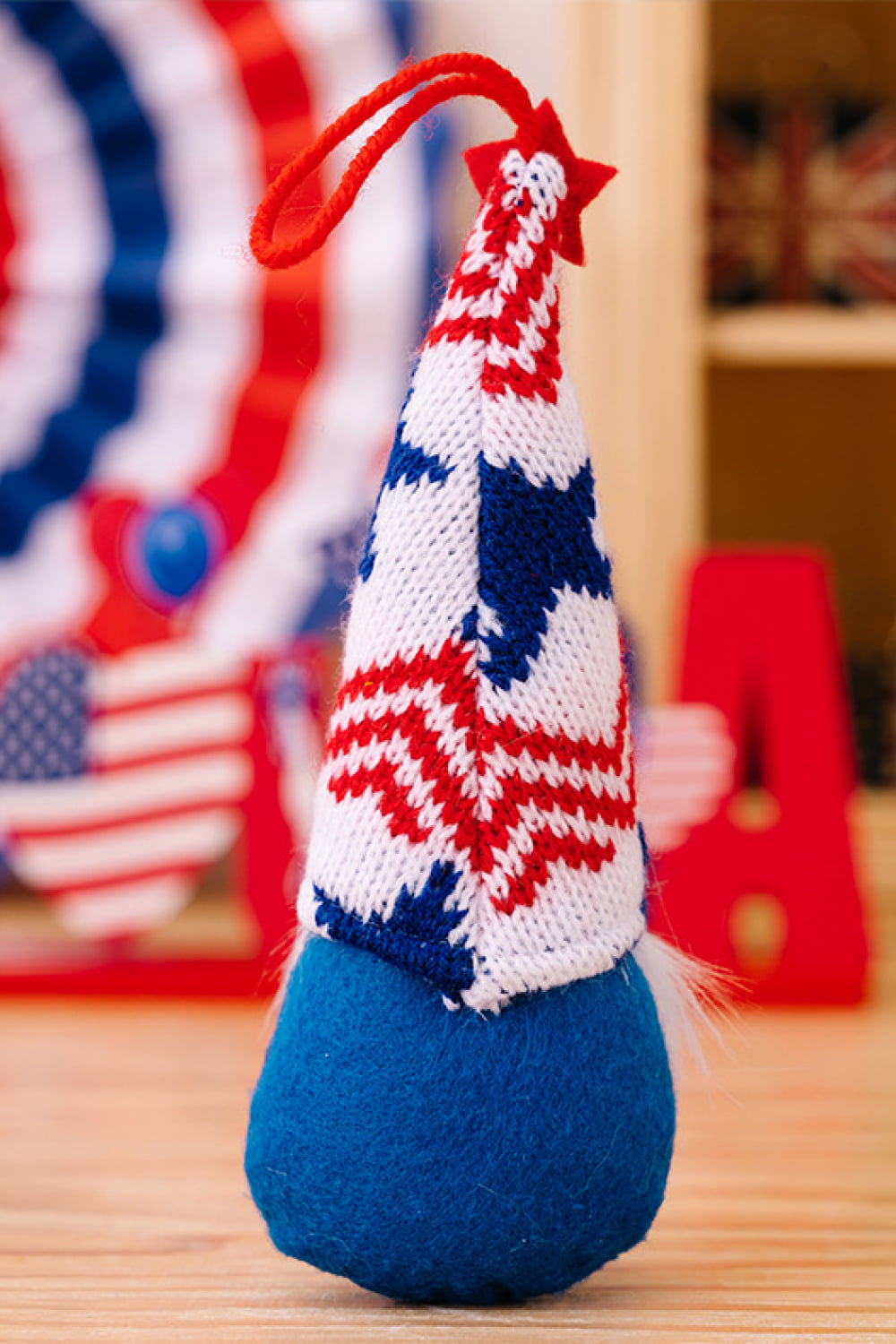 Four colorful Independence Day knit hanging gnomes, each with unique designs, perfect for festive decor.