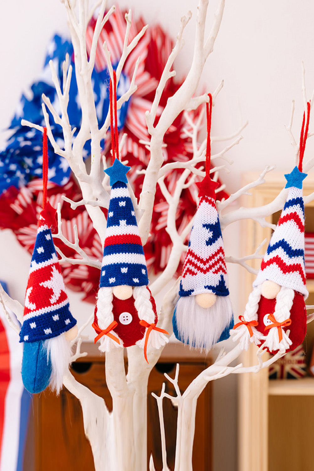 Four colorful Independence Day knit hanging gnomes, each with unique designs, perfect for festive decor.