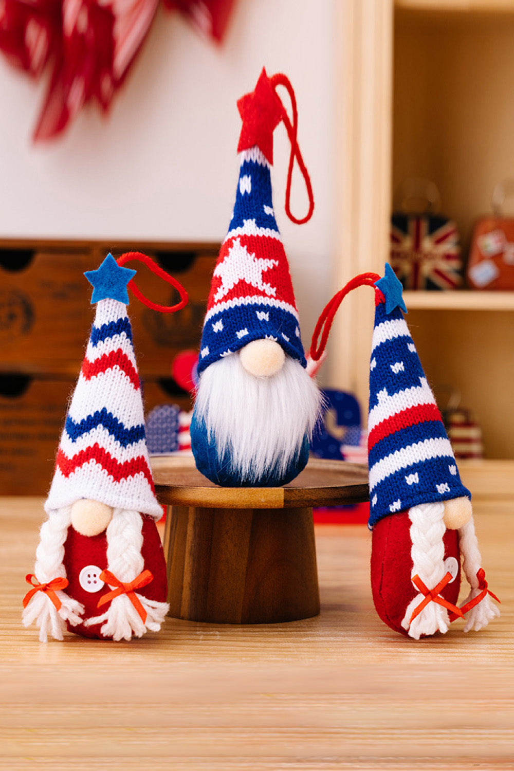 Four colorful Independence Day knit hanging gnomes, each with unique designs, perfect for festive decor.