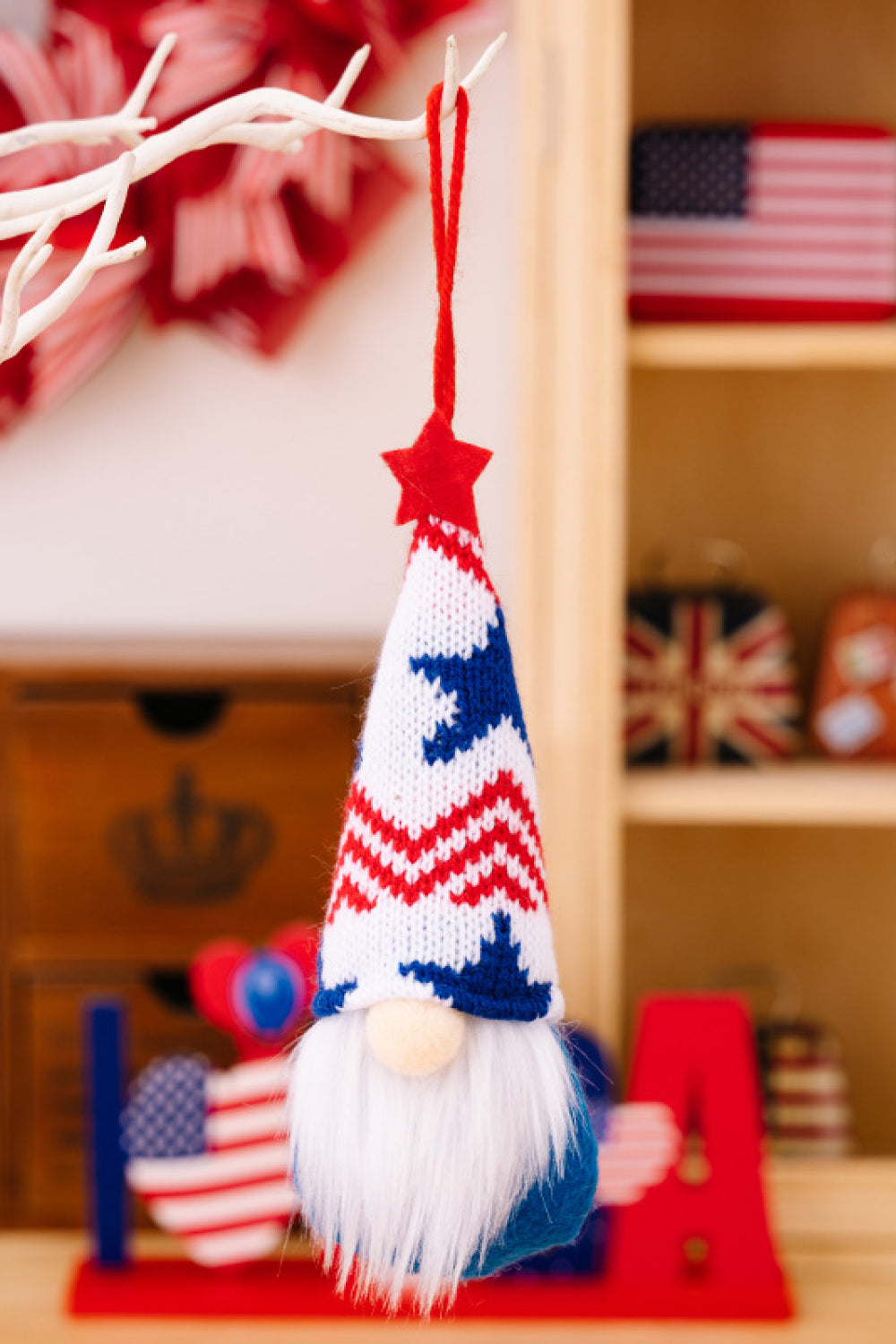 Four colorful Independence Day knit hanging gnomes, each with unique designs, perfect for festive decor.