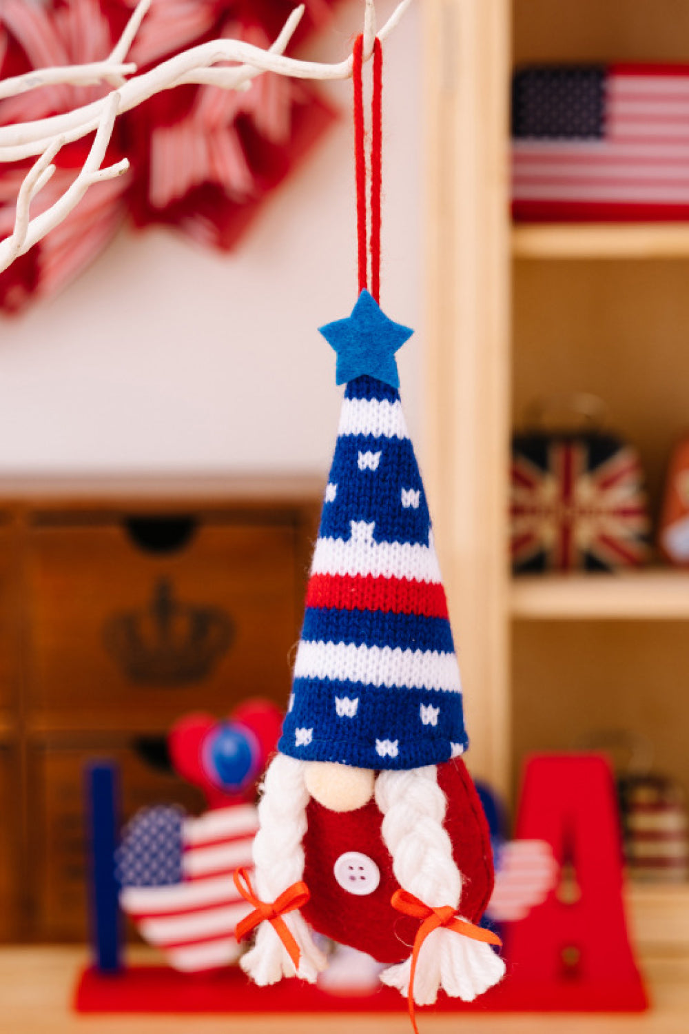 Four colorful Independence Day knit hanging gnomes, each with unique designs, perfect for festive decor.