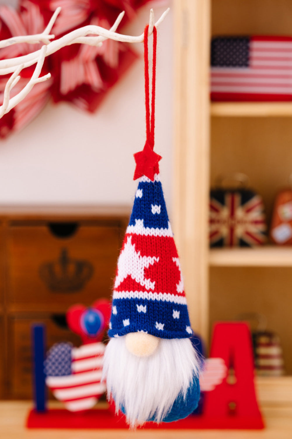 Four colorful Independence Day knit hanging gnomes, each with unique designs, perfect for festive decor.