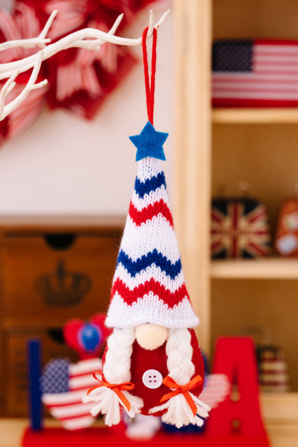 Four colorful Independence Day knit hanging gnomes, each with unique designs, perfect for festive decor.