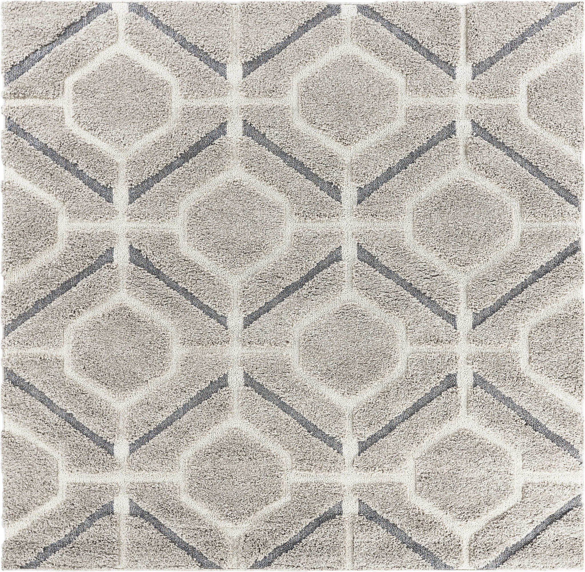 A plush 63" x 87" grey polypropylene rug with a hi-lo pile, enhancing a cozy living space.