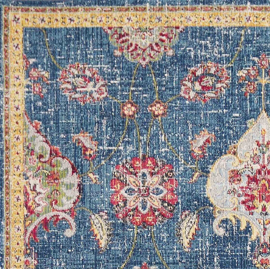 A beautiful 63" x 91" blue polypropylene rug featuring intricate vintage-inspired patterns, perfect for enhancing home decor.