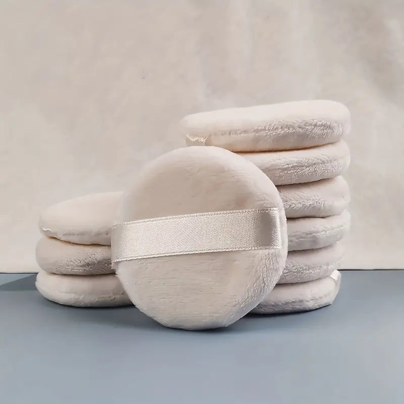 A set of 7 round makeup sponges with durable straps, designed for seamless blending of foundation and concealer.