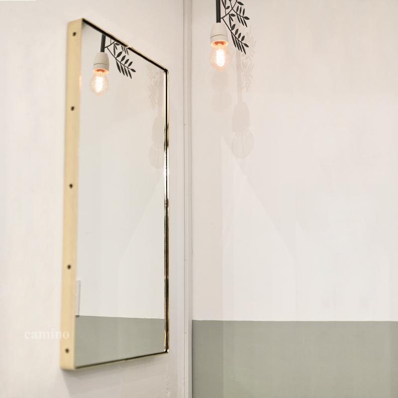 A large 80" x 80" x 4" Clear Steel Glass Mirror with a stylish brass frame, showcasing a minimalist design suitable for various interior styles.