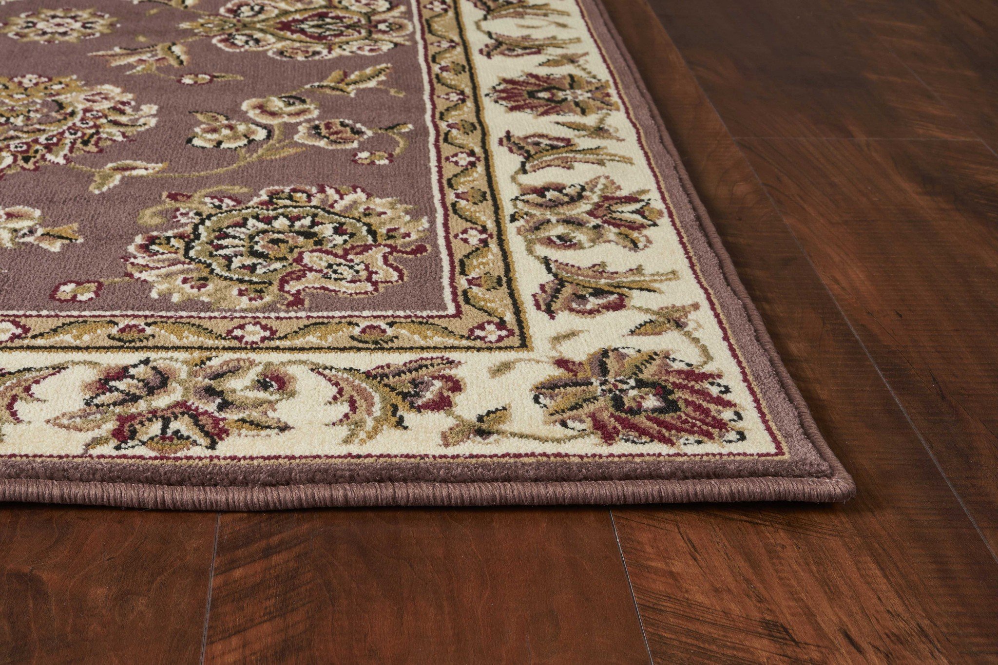 A beautiful 9' x 13' Polypropylene Area Rug in plum and ivory floral design, enhancing a stylish living space.