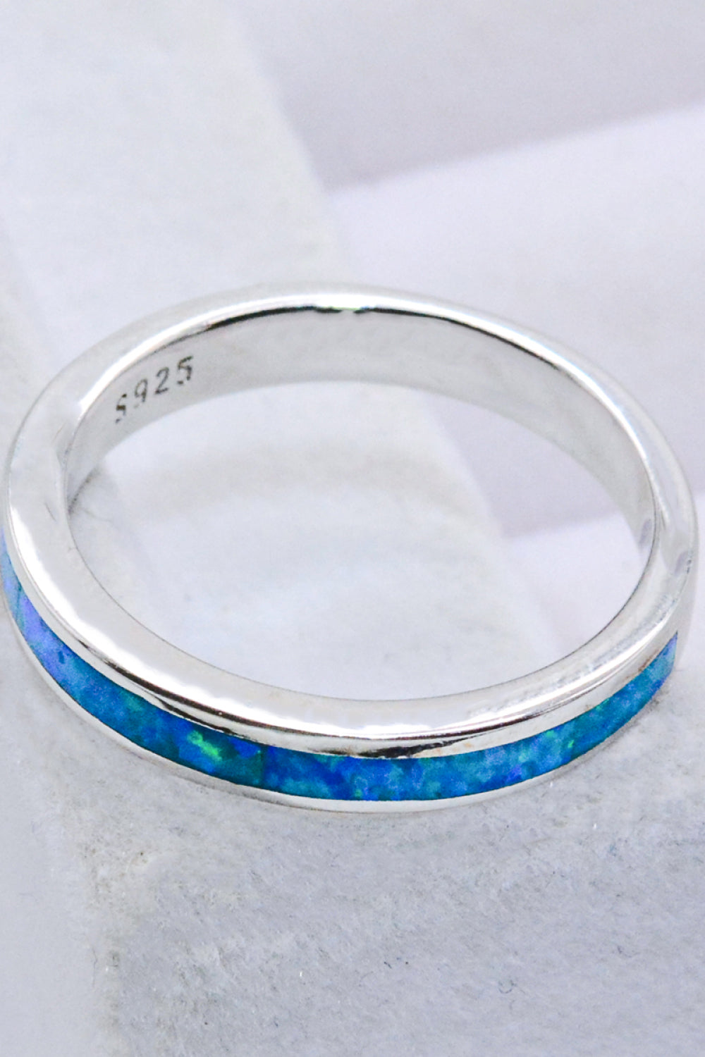 A minimalist 925 sterling silver ring featuring a stunning sky blue opal, elegantly polished and presented in a matching gift box.