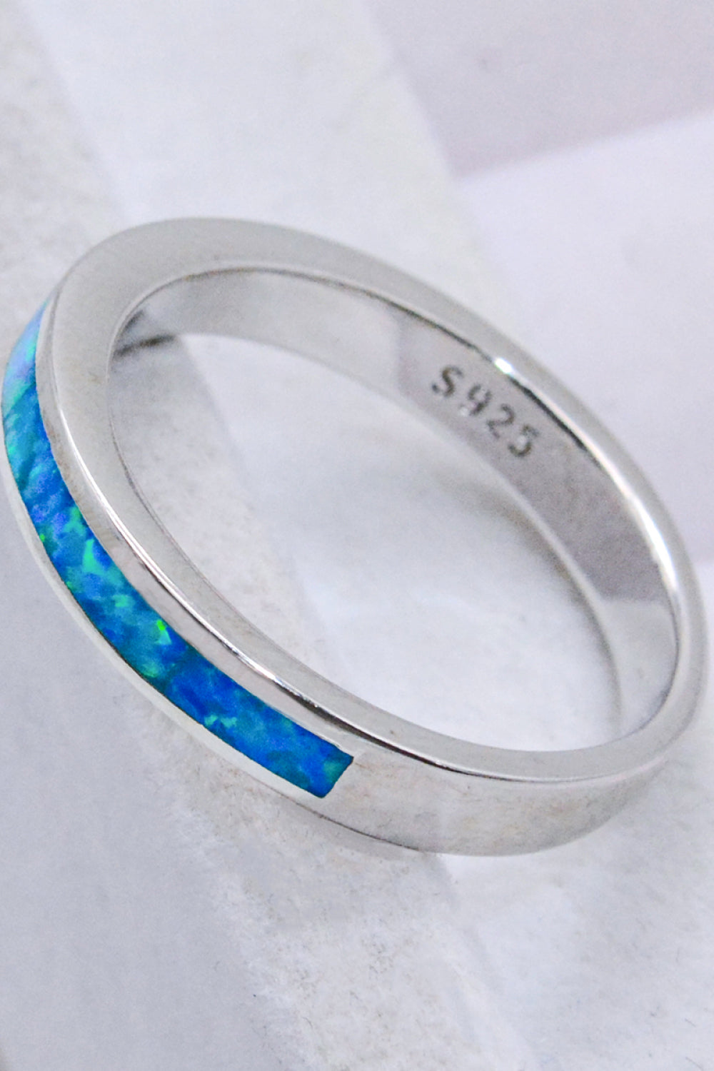 A minimalist 925 sterling silver ring featuring a stunning sky blue opal, elegantly polished and presented in a matching gift box.