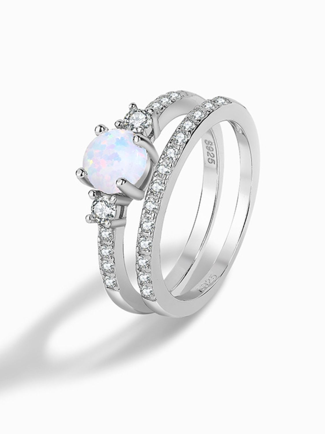 A modern 925 sterling silver opal split shank ring displayed in a flat lay style, showcasing its minimalist design and polished finish.