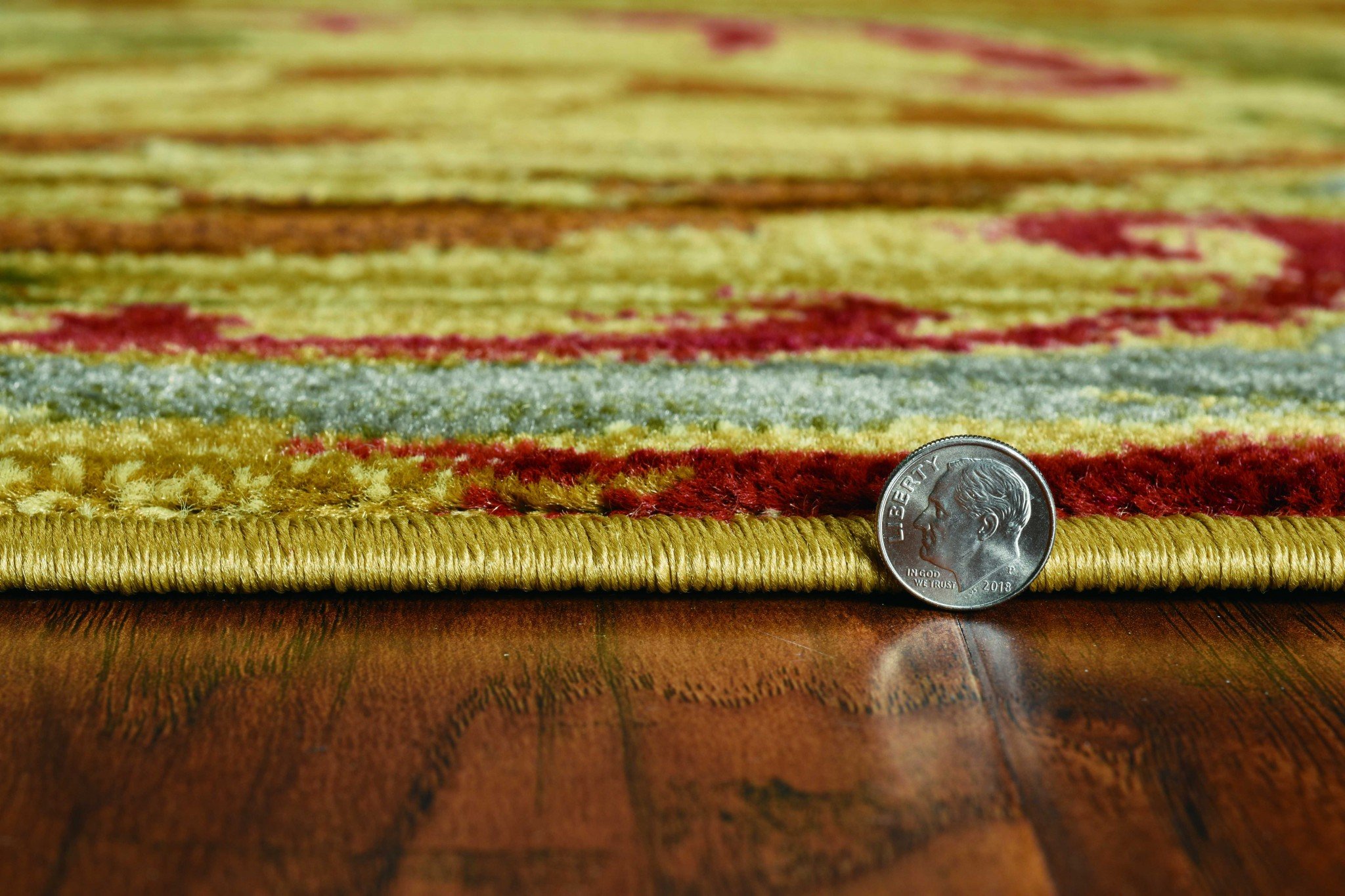 A luxurious 94" x 118" gold polypropylene rug featuring intricate patterns, perfect for enhancing home decor.