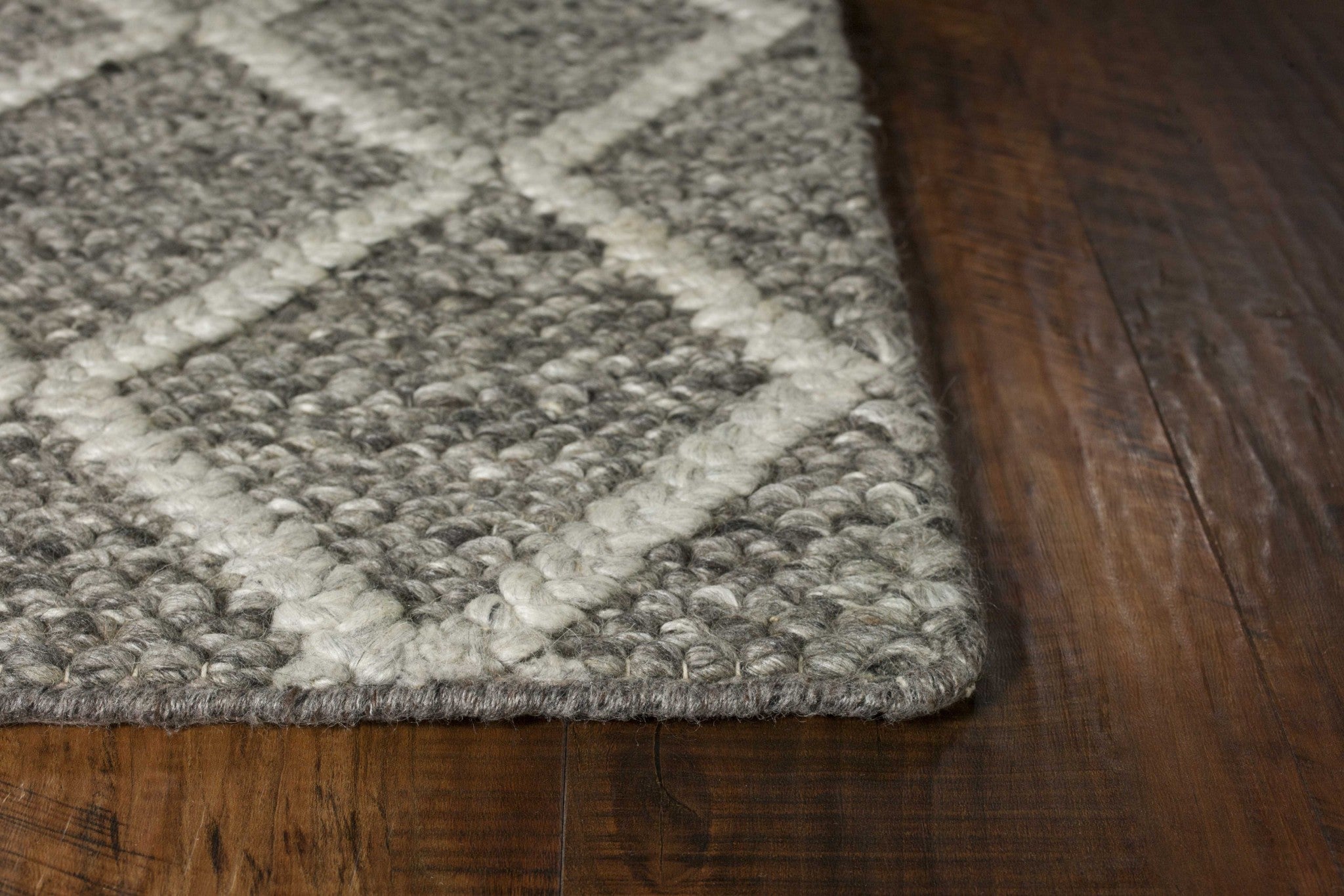 A luxurious 9x13 dark grey wool area rug featuring a diamond pattern, perfect for enhancing modern home decor.