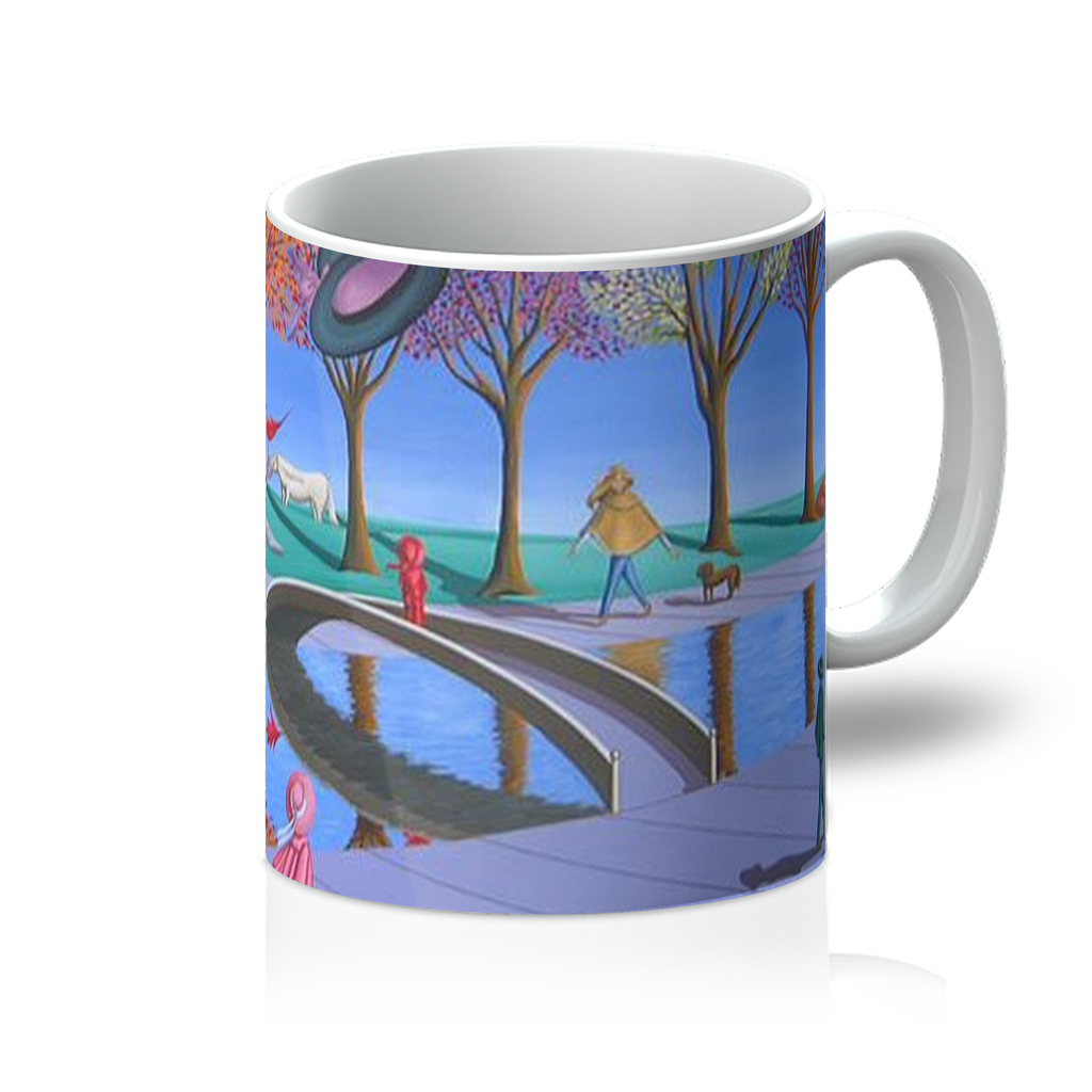 A Day In The Park Mug featuring vibrant artwork by Sharon Tatem, showcasing a serene park scene with a glossy finish and sturdy handle.