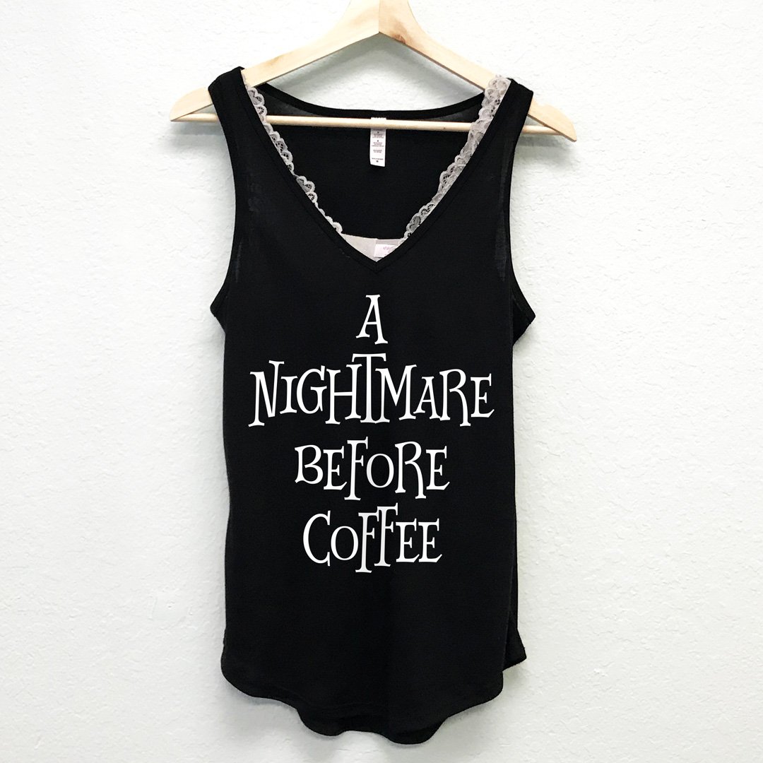 A black V-neck tank top with the phrase 'A Nightmare Before Coffee' printed on it, showcasing a stylish and casual design.