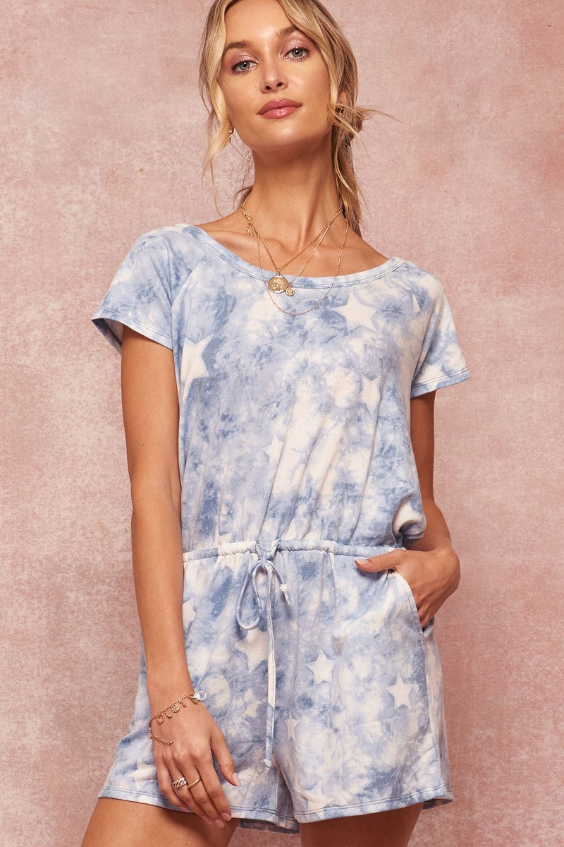 A stylish blue star-pattern tie-dye knit romper featuring a round neckline, short sleeves, and an open surplice back with tie closure.