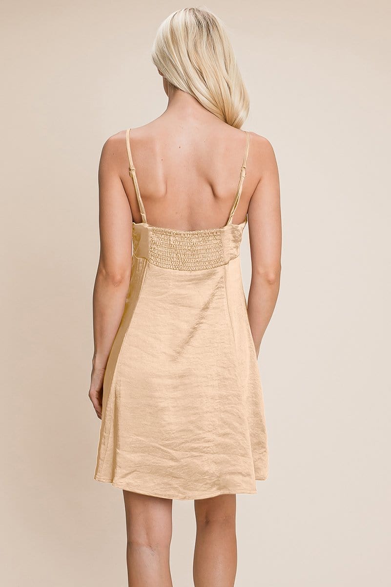 A stylish adjustable spaghetti strap satin cami slip dress in a mini length, featuring a smocked back and elegant design, perfect for various occasions.