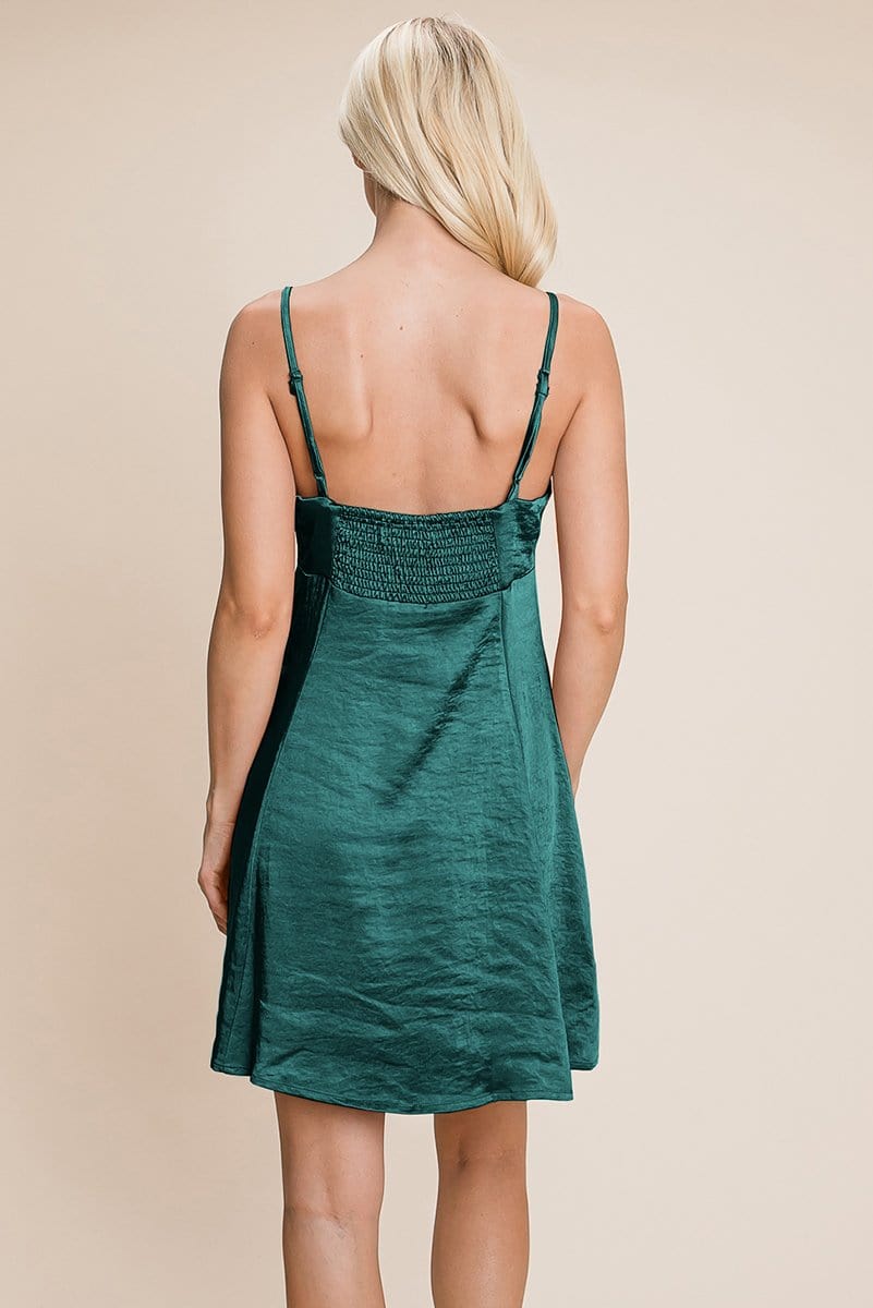 A stylish adjustable spaghetti strap satin cami slip dress in a mini length, featuring a smocked back and elegant design, perfect for various occasions.