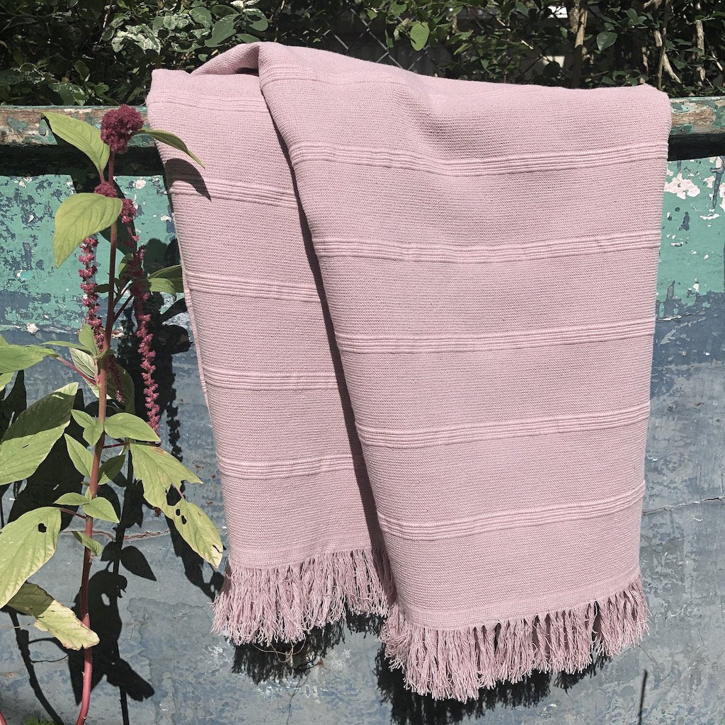 Aegean Turkish Towel featuring subtle stripes, terry backing, and eyelash fringe, showcasing its vibrant colors and craftsmanship.