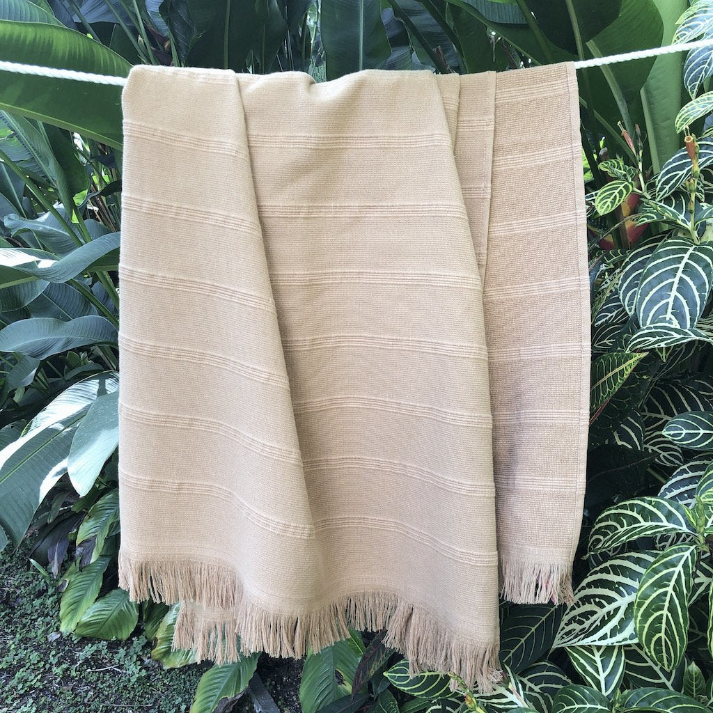 Aegean Turkish Towel featuring subtle stripes, terry backing, and eyelash fringe, showcasing its vibrant colors and craftsmanship.