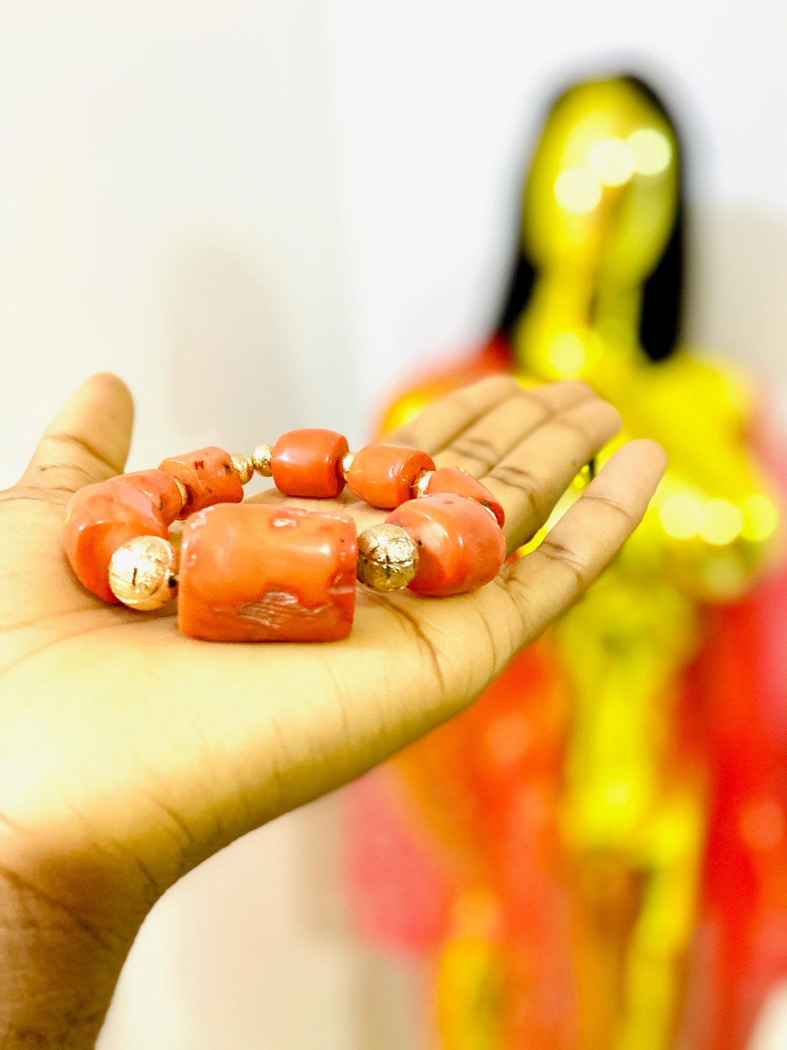 A beautifully handcrafted African Coral Bracelet featuring antique coral gemstones, showcasing vibrant colors and intricate designs.