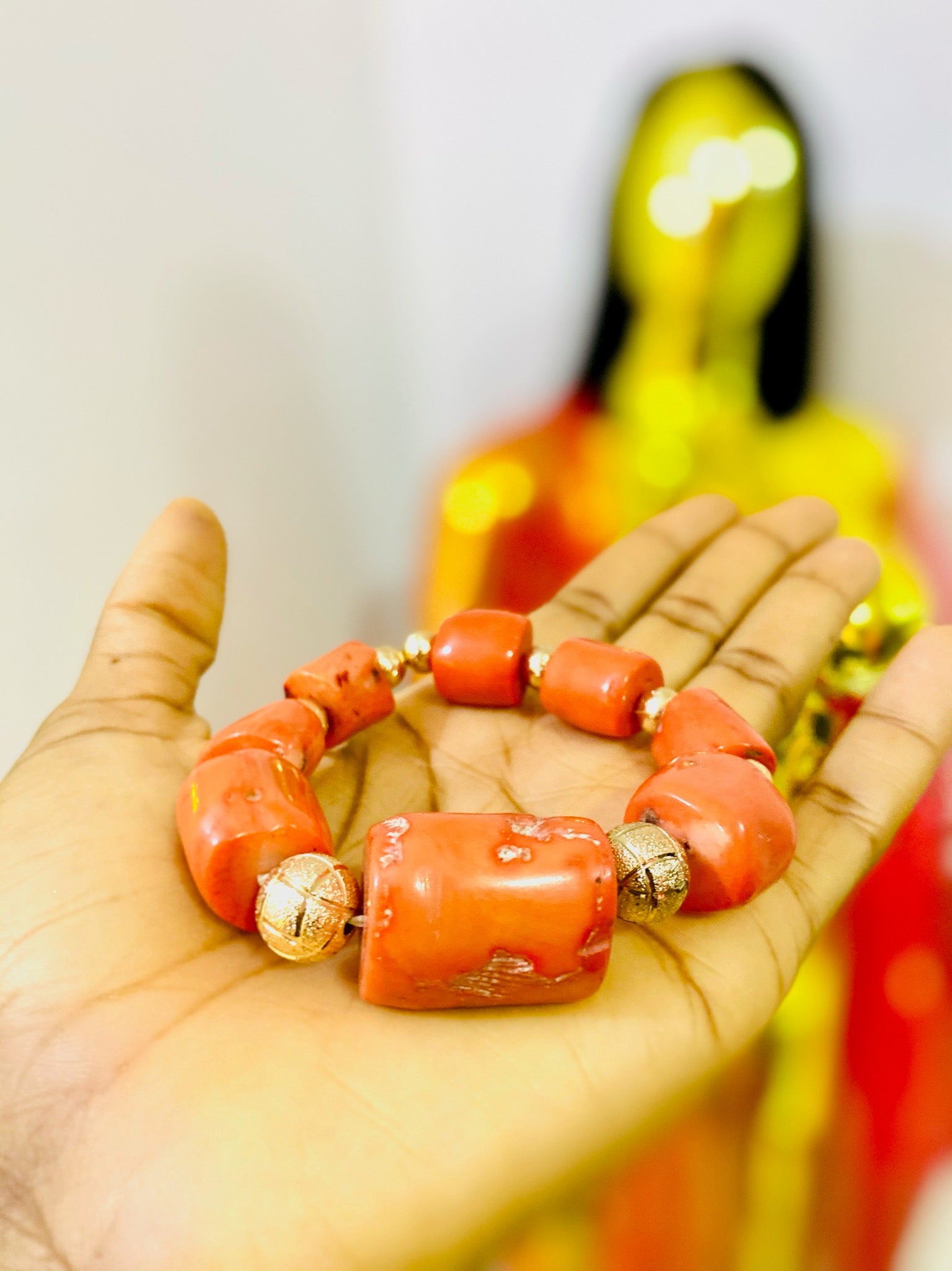 A beautifully handcrafted African Coral Bracelet featuring antique coral gemstones, showcasing vibrant colors and intricate designs.