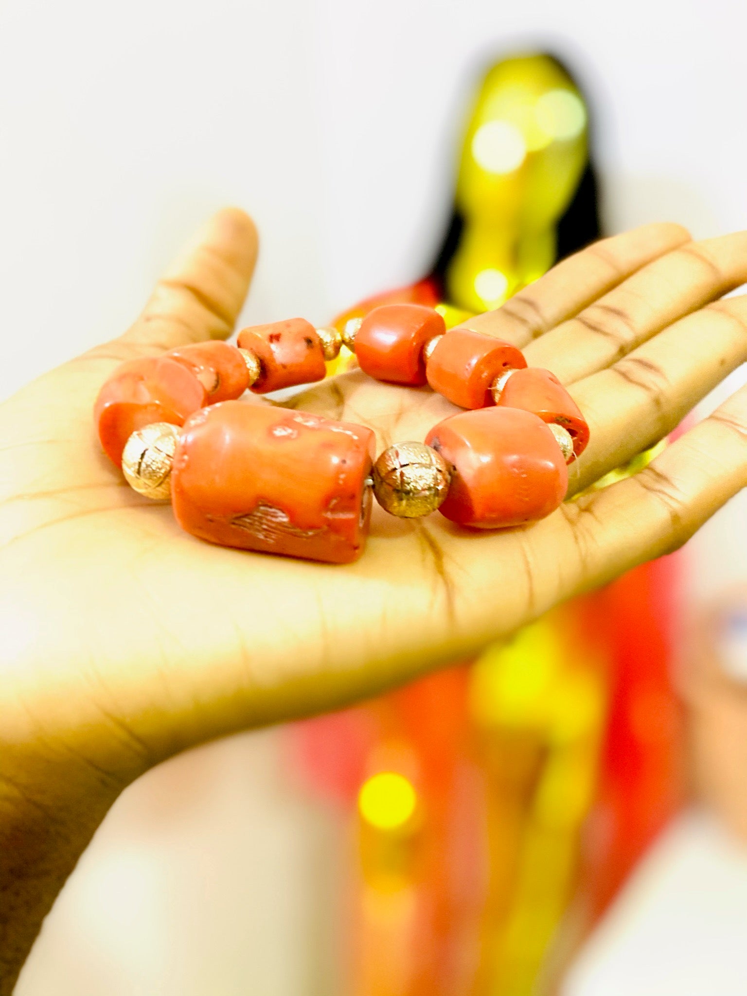 A beautifully handcrafted African Coral Bracelet featuring antique coral gemstones, showcasing vibrant colors and intricate designs.