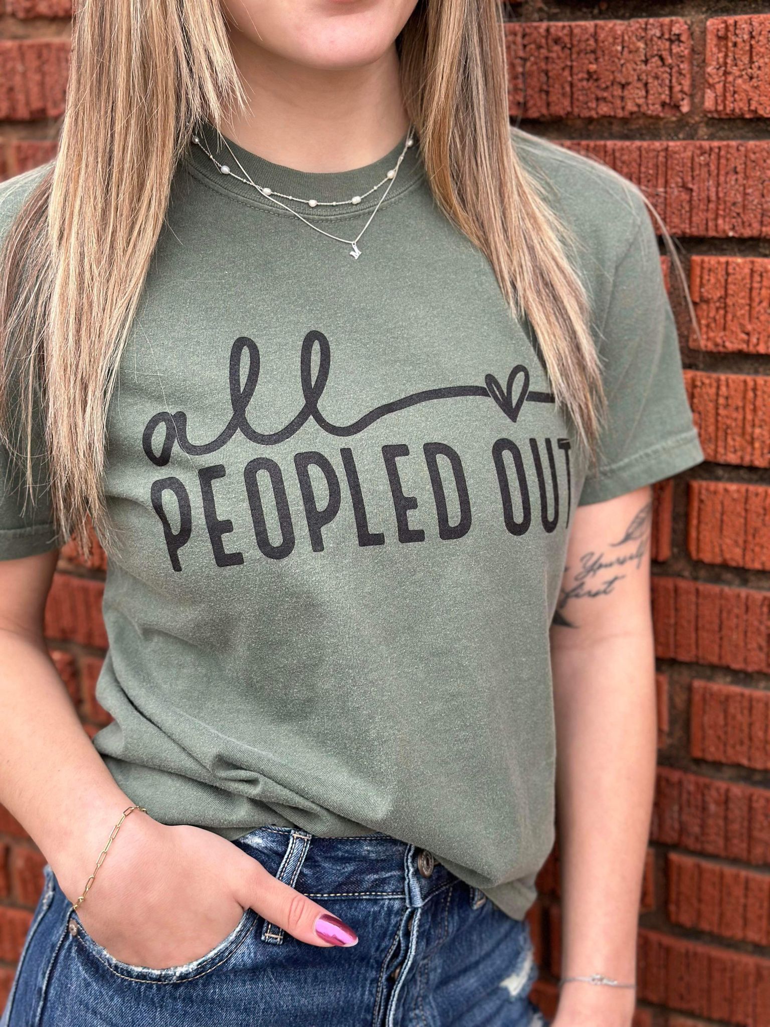 All Peopled Out Tee in Moss color, showcasing a cozy unisex design made from 100% cotton, perfect for casual wear.