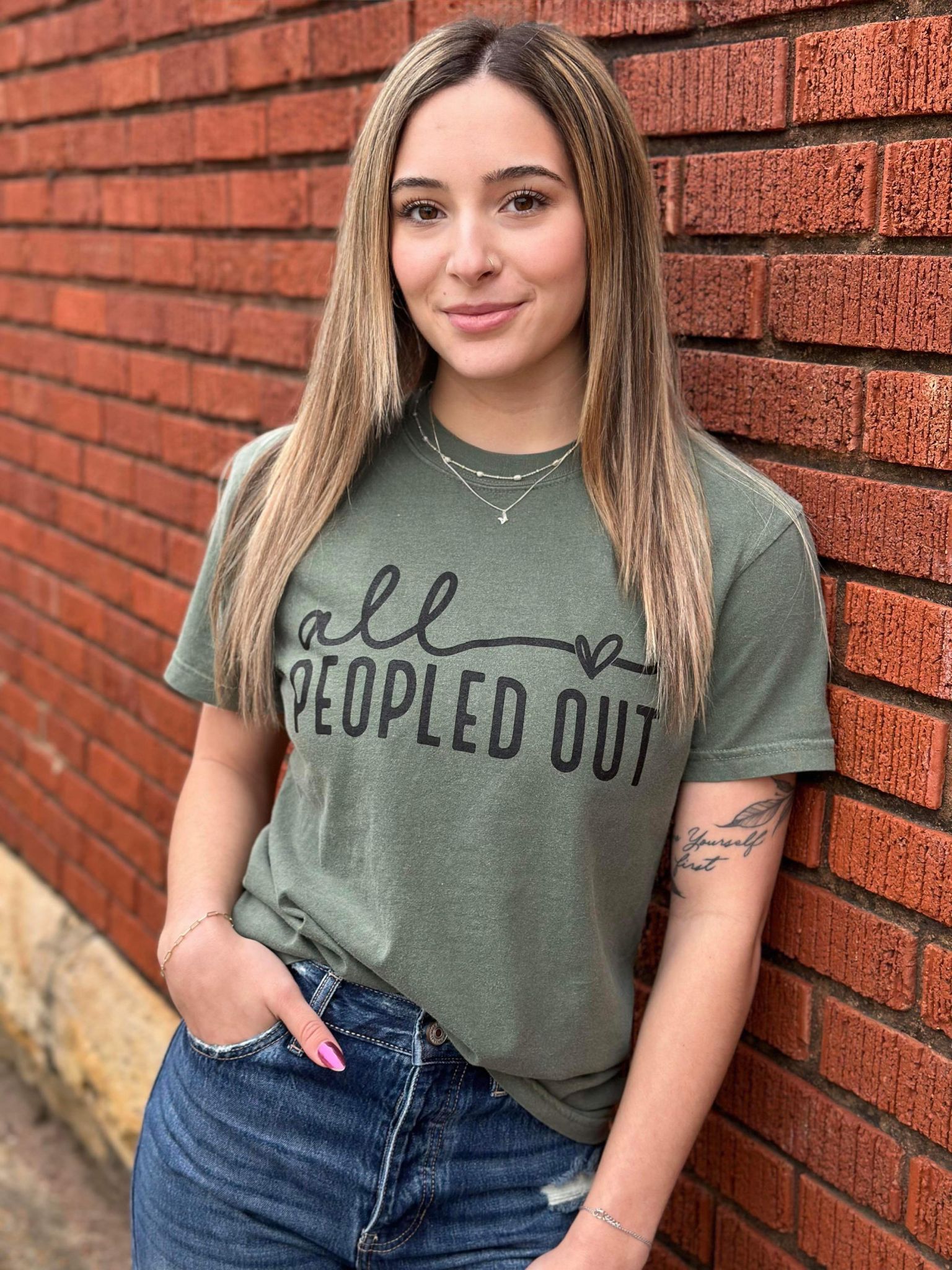 All Peopled Out Tee in Moss color, showcasing a cozy unisex design made from 100% cotton, perfect for casual wear.