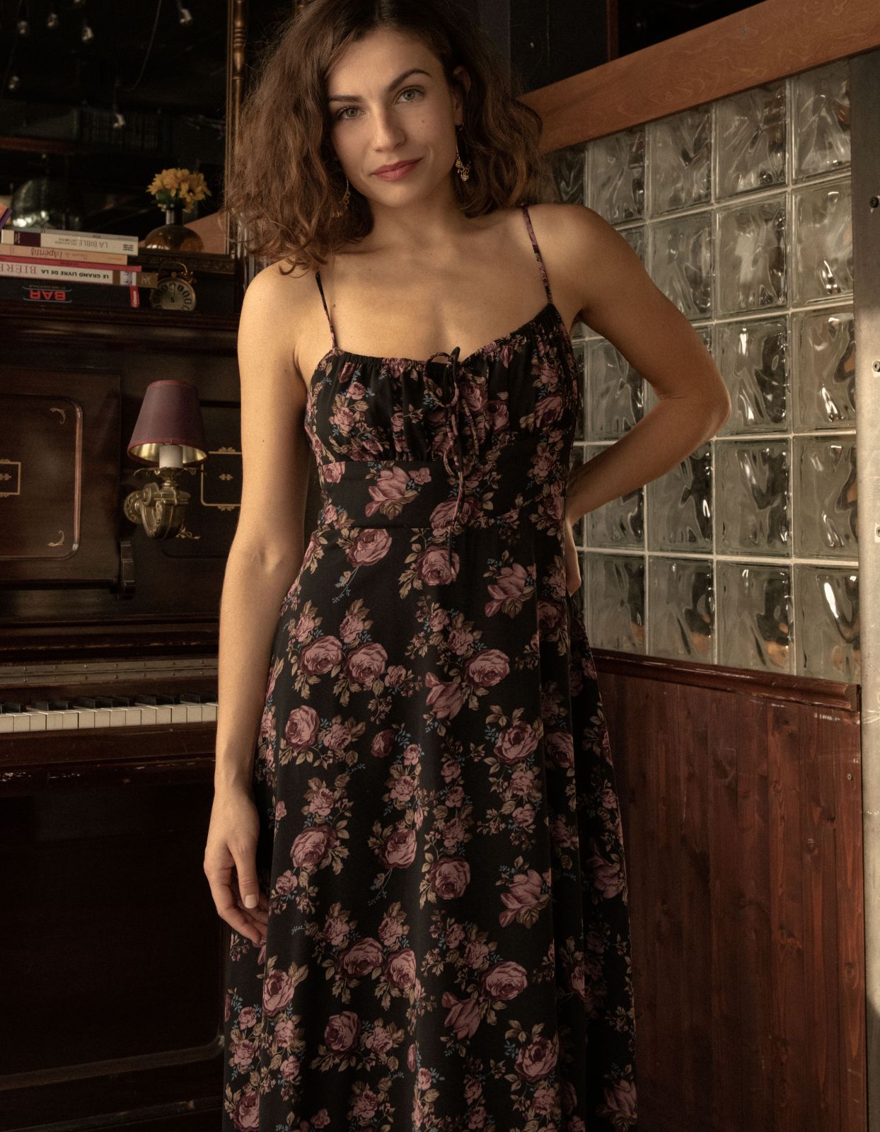 Alaia Midi Dress featuring a floral print with adjustable straps and an empire waistline, elegantly displayed on a mannequin.