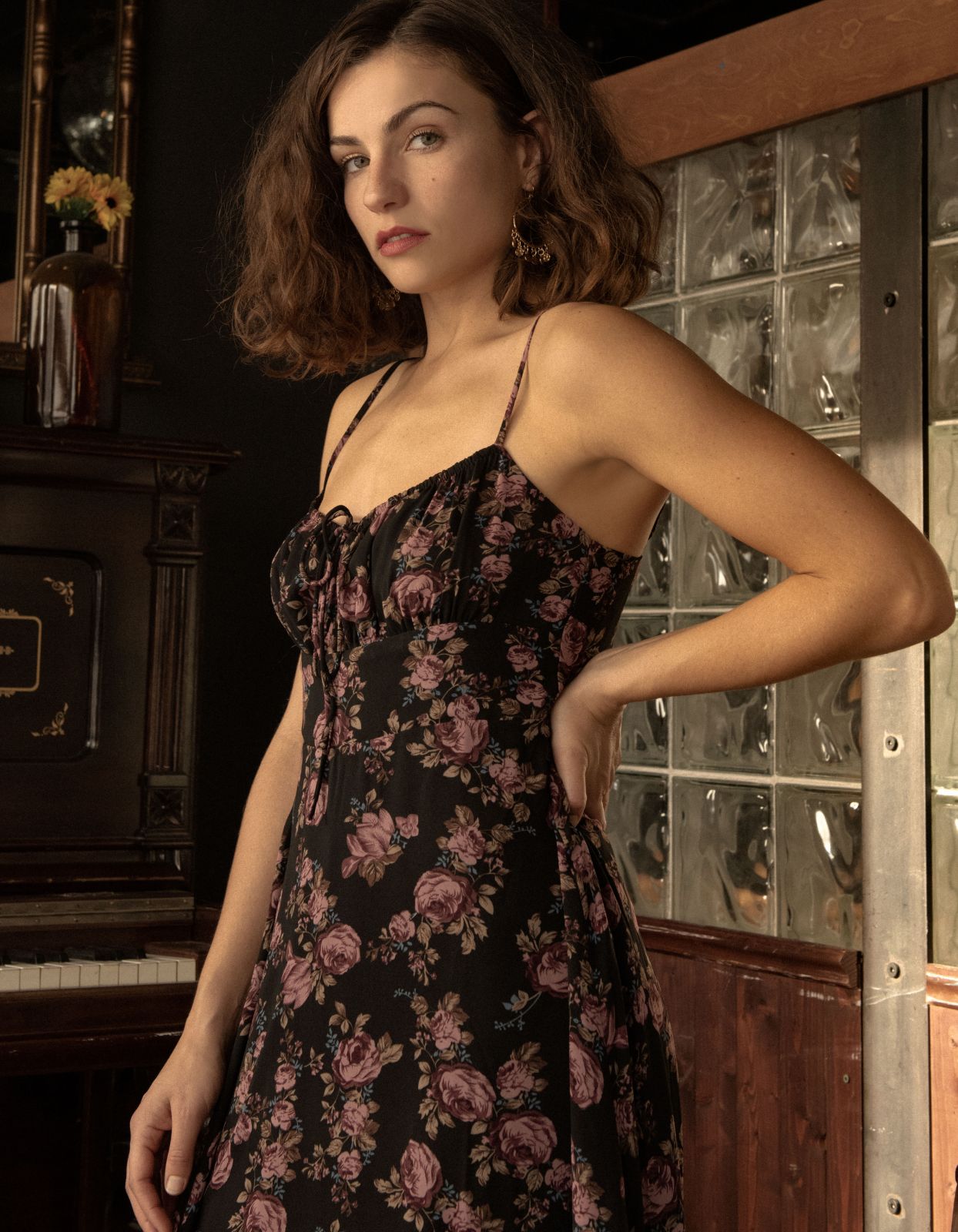 Alaia Midi Dress featuring a floral print with adjustable straps and an empire waistline, elegantly displayed on a mannequin.