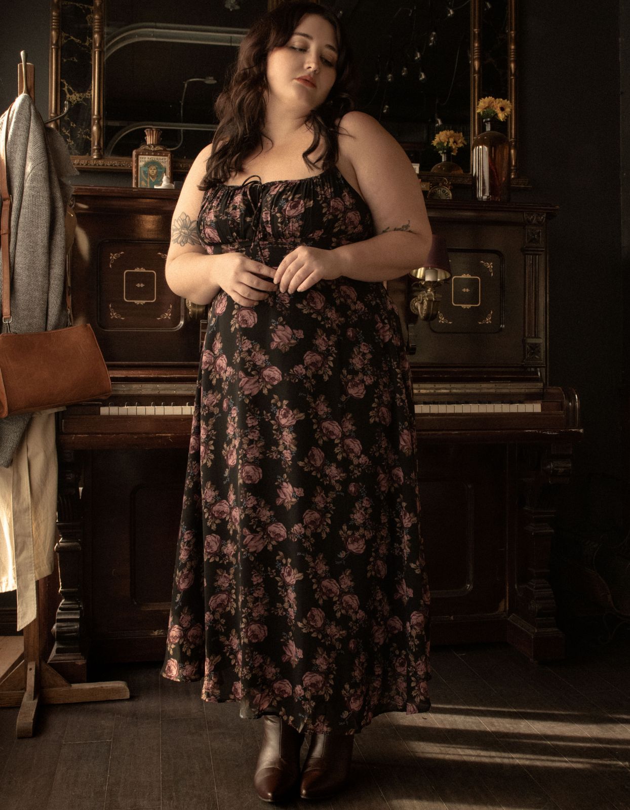 Alaia Midi Dress featuring a floral print with adjustable straps and an empire waistline, elegantly displayed on a mannequin.