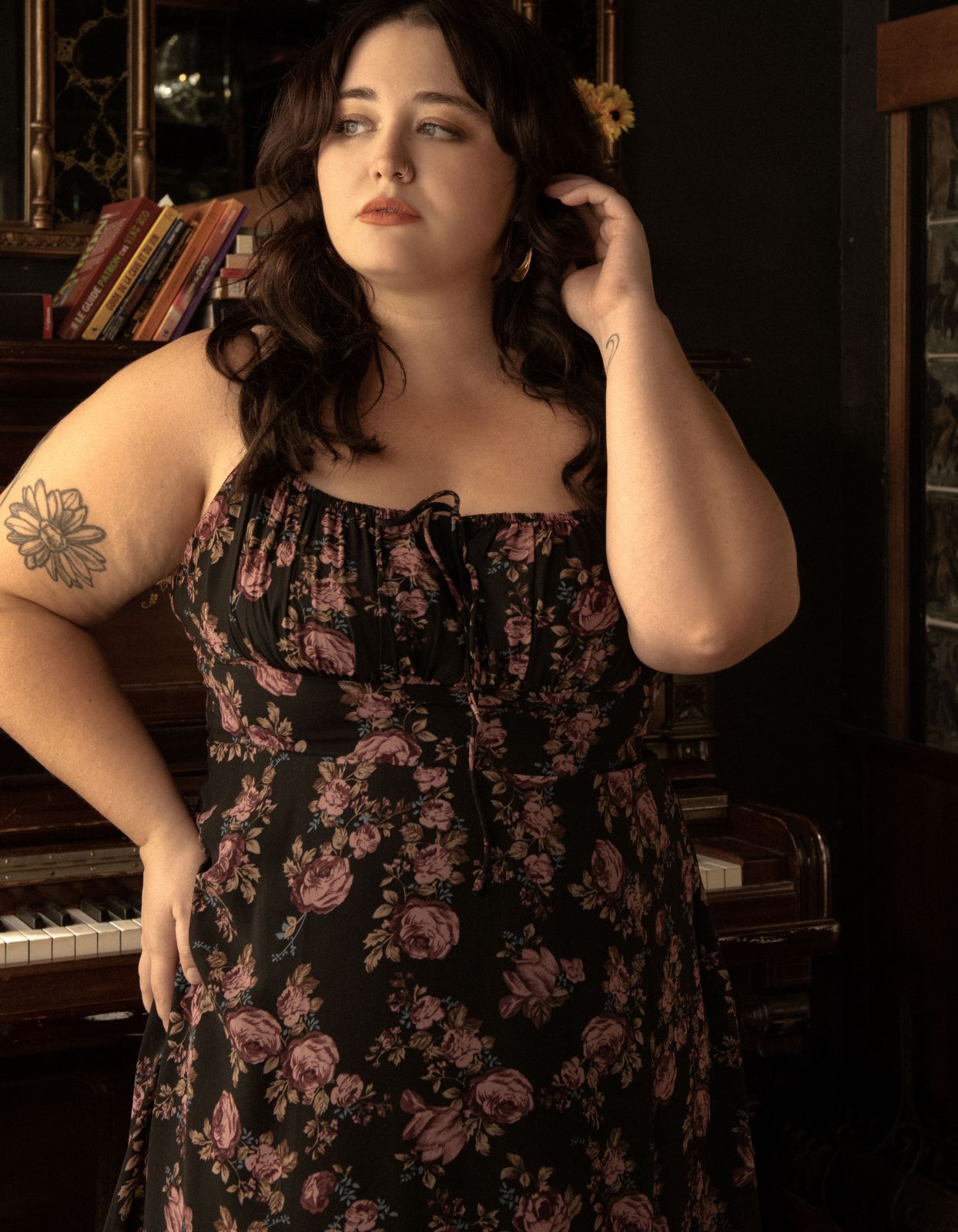 Alaia Midi Dress featuring a floral print with adjustable straps and an empire waistline, elegantly displayed on a mannequin.