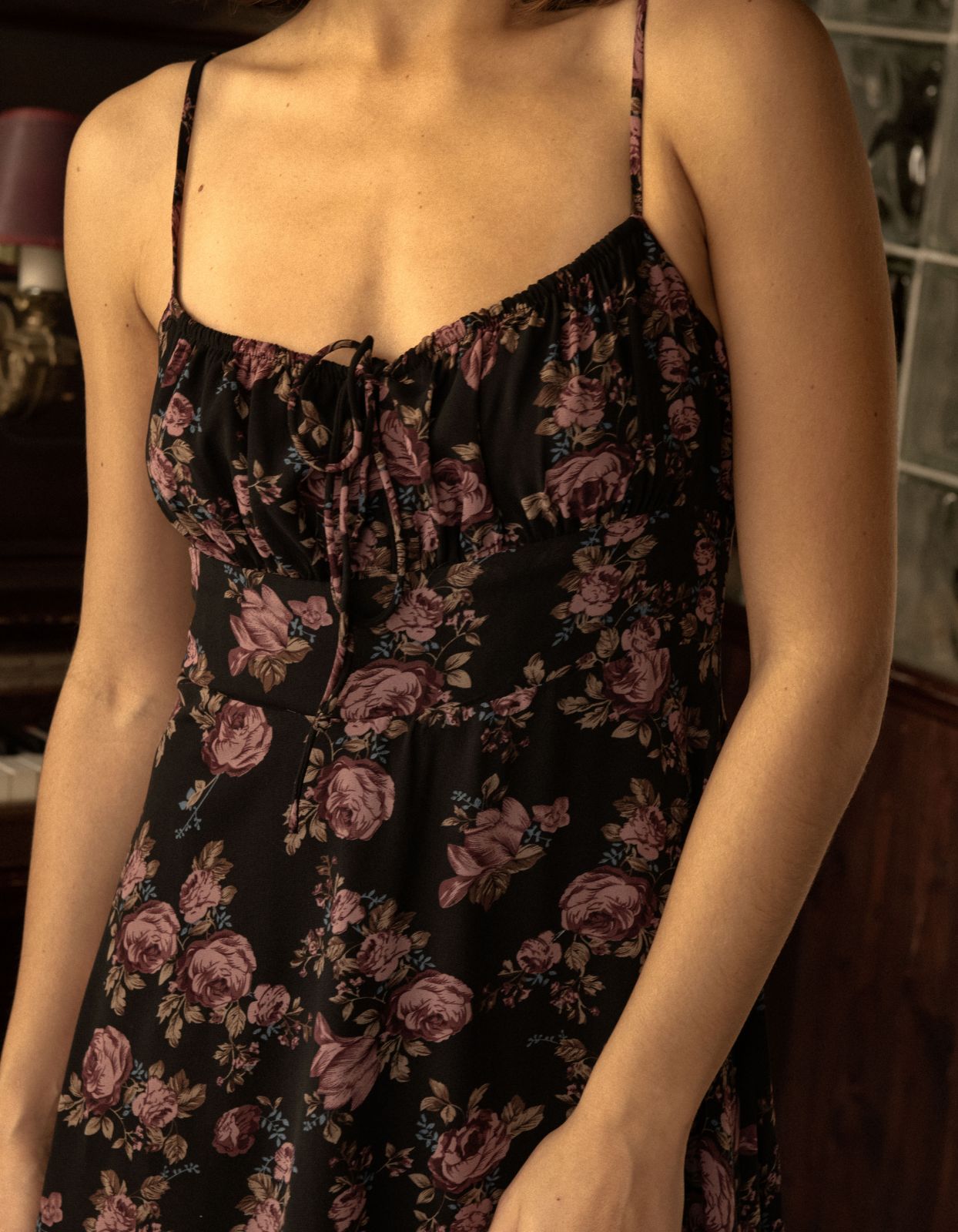 Alaia Midi Dress featuring a floral print with adjustable straps and an empire waistline, elegantly displayed on a mannequin.