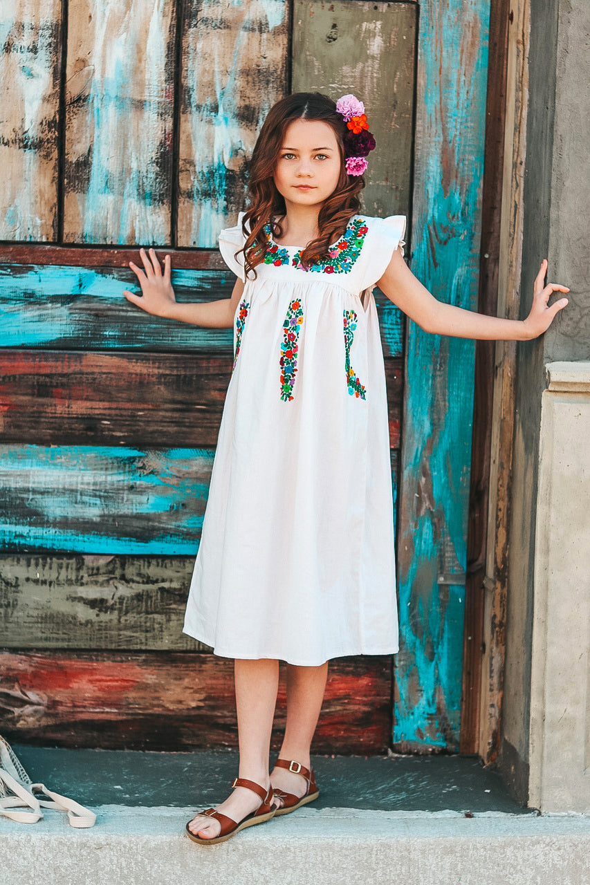 Allegra Sundress featuring flutter sleeves and multicolor hand embroidery on organic cotton fabric.