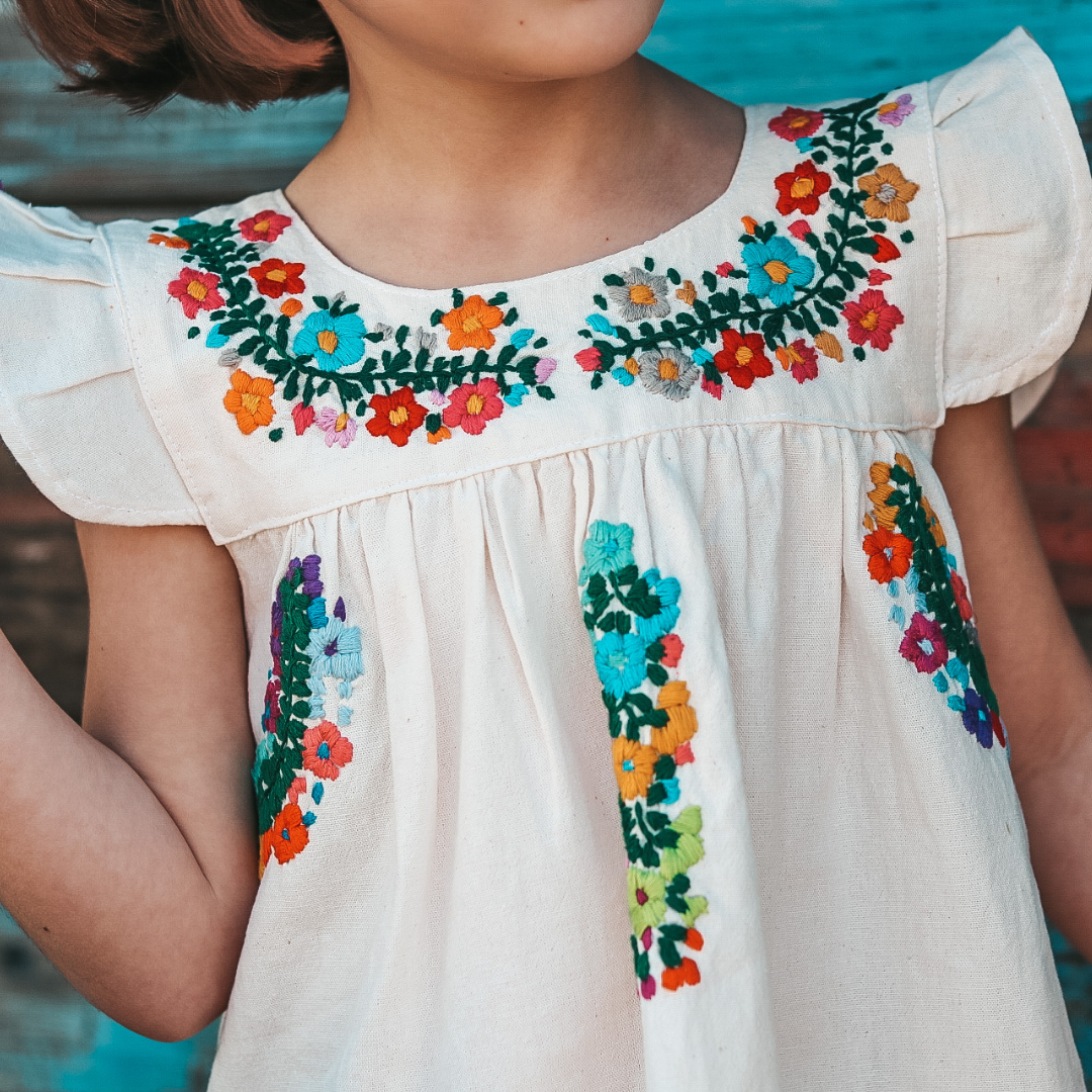 Allegra Sundress featuring flutter sleeves and multicolor hand embroidery on organic cotton fabric.