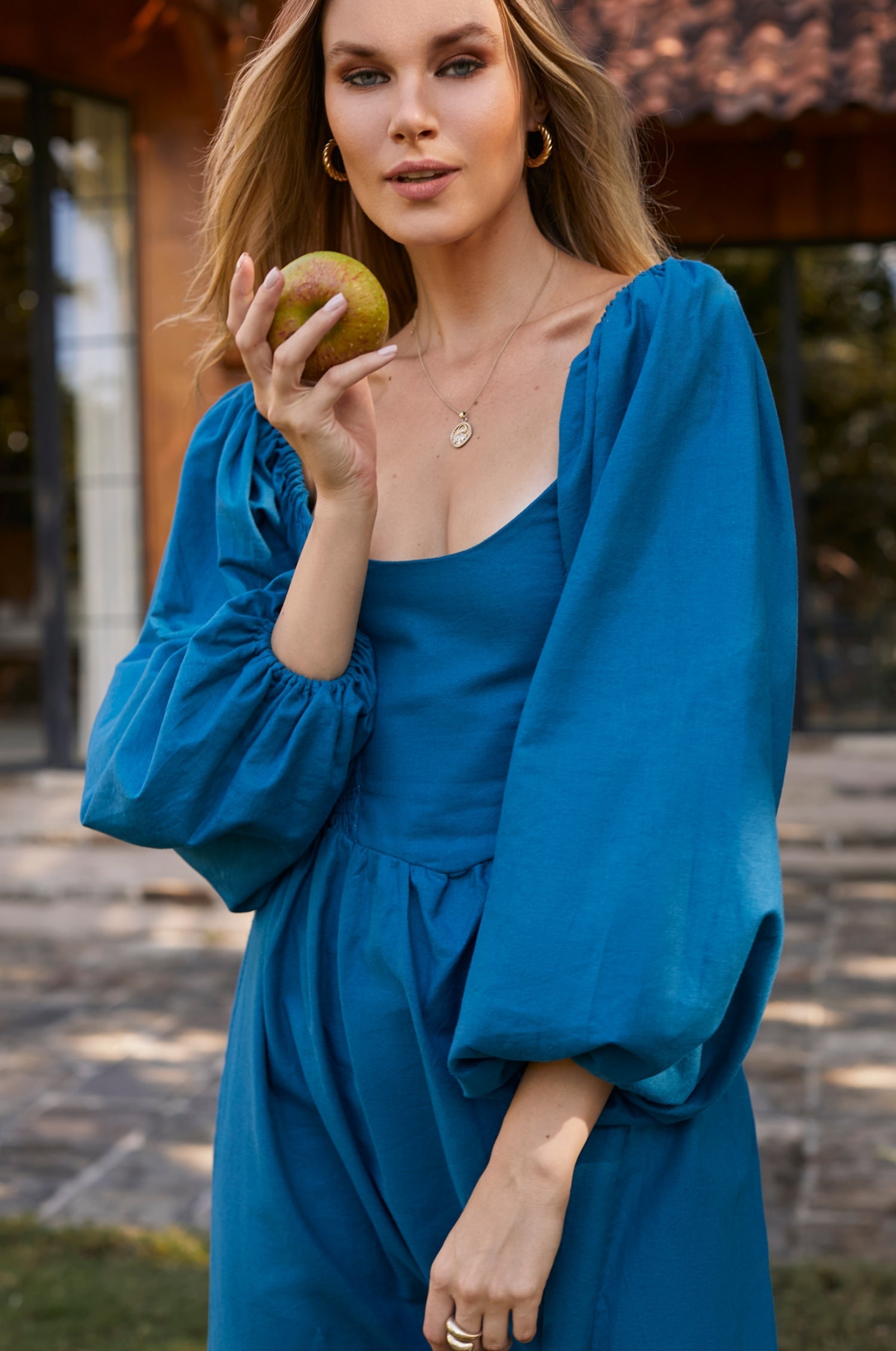 Alila Smocked Linen Midi Dress featuring a smocked bodice, gathered puff sleeves, and an oval neckline, made from 100% pure linen.