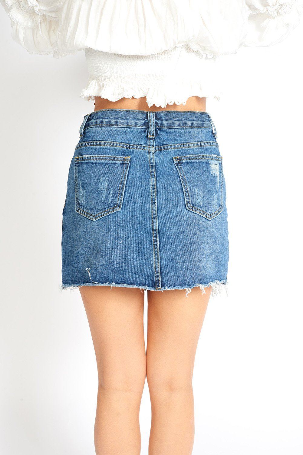 Amalia Ripped Denim Mini Skort featuring distressed details, built-in shorts, and frayed hem, perfect for casual summer wear.