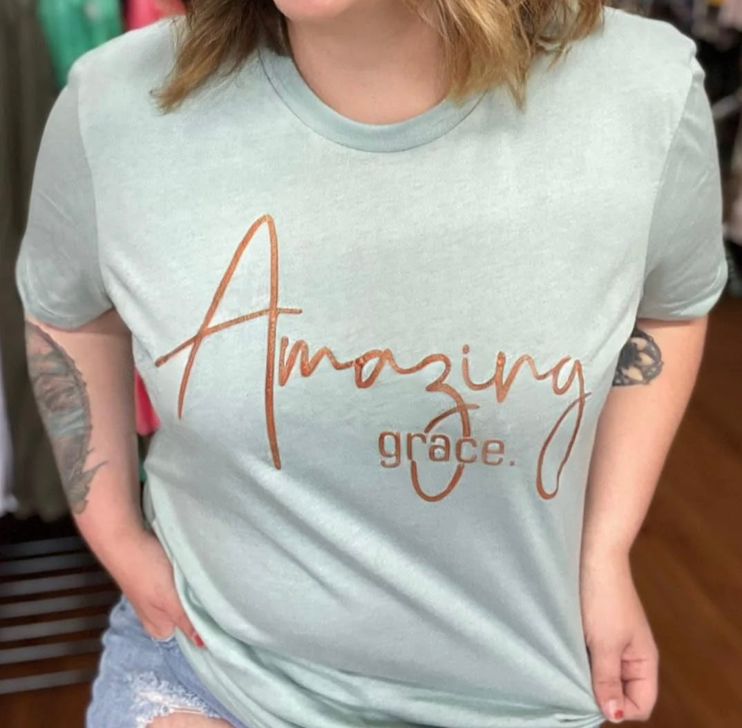 Amazing Grace T-Shirt in dusty blue with bronze ink design, showcasing a stylish and comfortable fit.