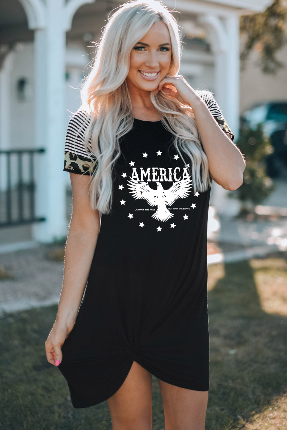 AMERICA Eagle Graphic Twisted Dress featuring a unique eagle graphic, casual mini length, and asymmetrical hem design.