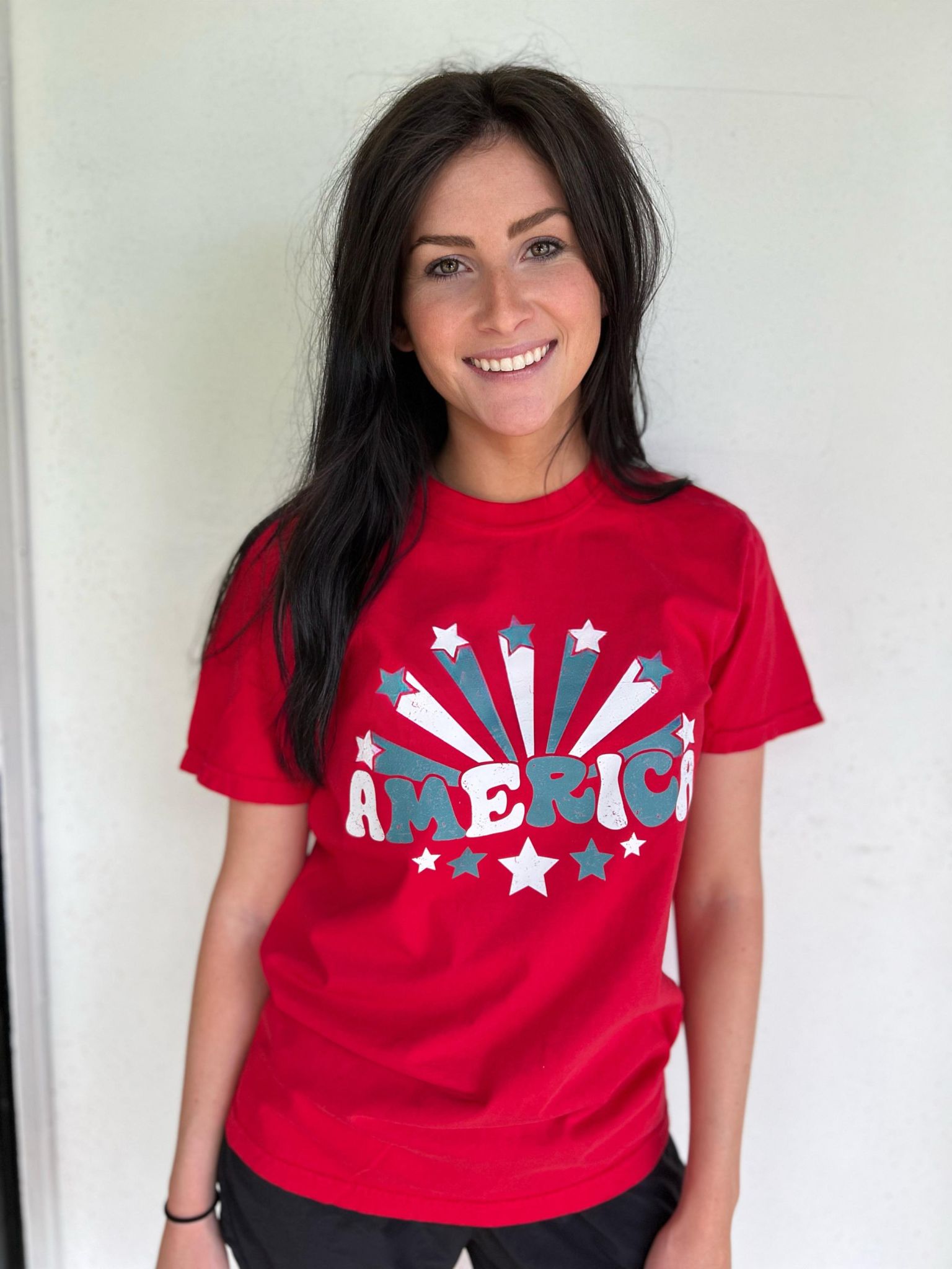 A vibrant red America Stars Tee featuring a patriotic design, perfect for 4th of July celebrations.